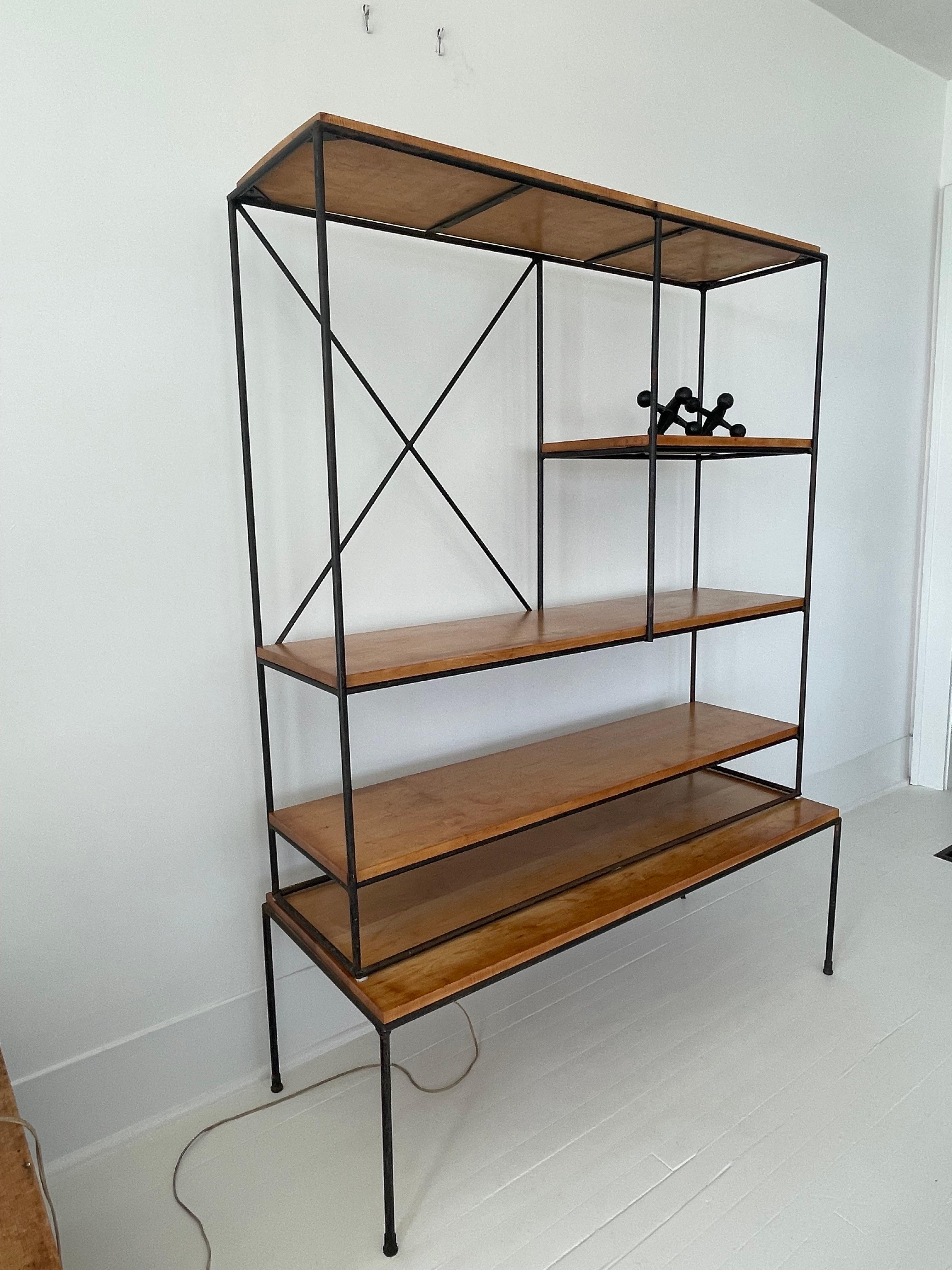 Gorgeous Mid Century two piece shelving system by Paul McCobb and part of the “Planner Group” manufactured by Winchendon in the 1950s. Original maple wood shelves and black wrought iron frame . Pieces can be used together or separate as shown in the