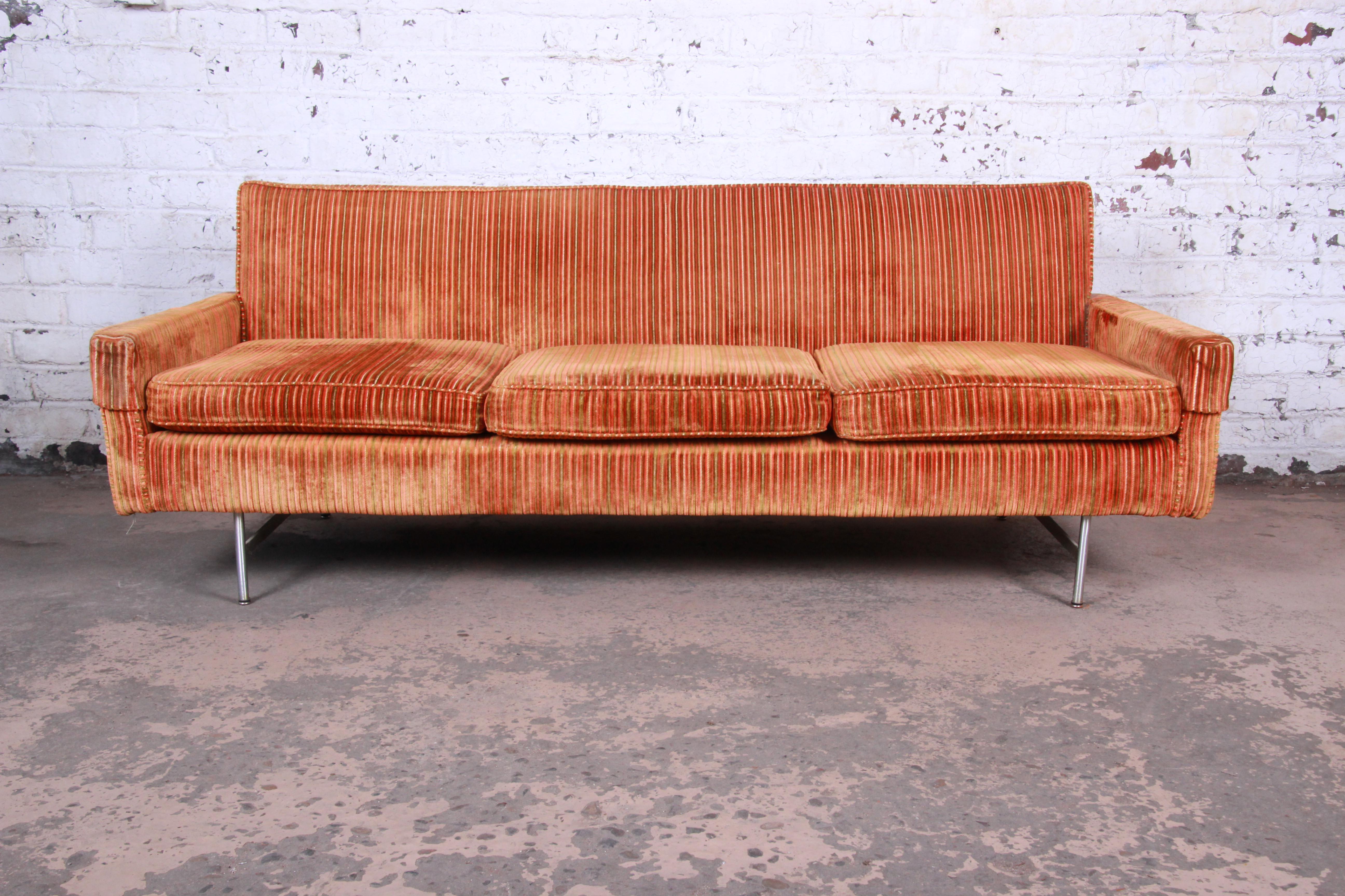 A rare and exceptional Mid-Century Modern sofa from the Linear Group line by Paul McCobb for Calvin Furniture. The sofa features McCobb's sleek, Minimalist midcentury design and beautiful original striped upholstery in orange and green. It rests on