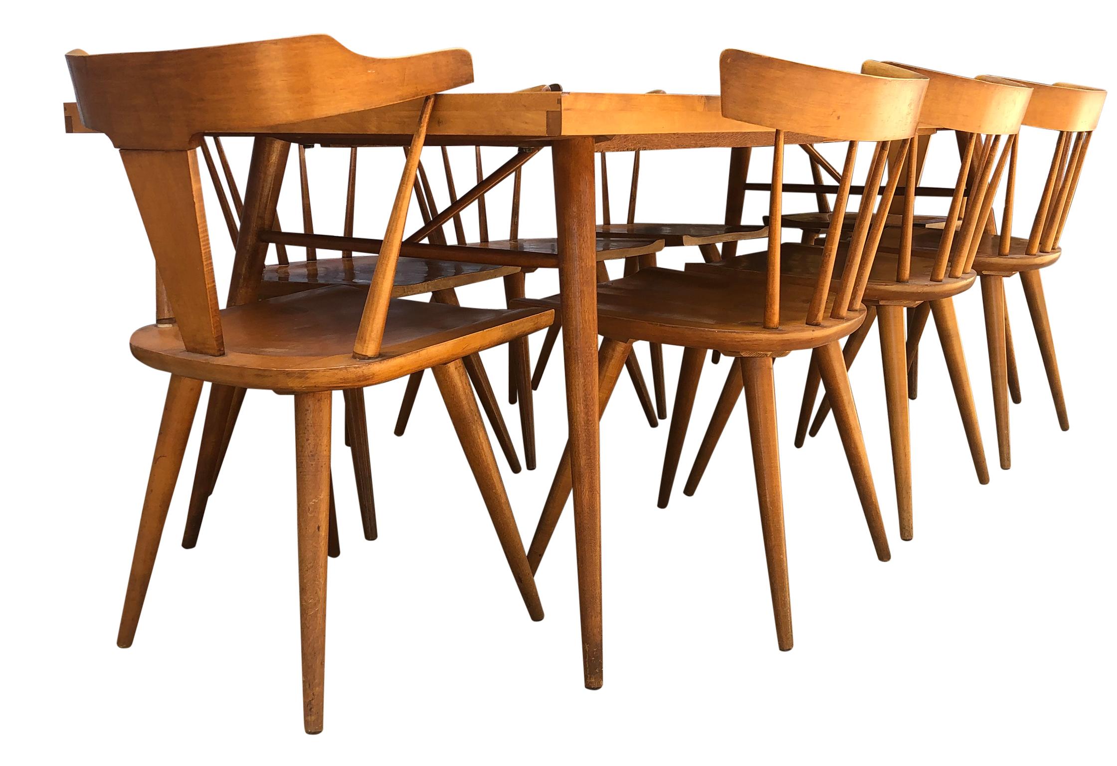 Beautiful early 1950s Paul McCobb maple dining table set with 8 maple chairs. Great midcentury design. Totally refinished dining table #1522 with 4 tapered legs with dowel supports. Solid maple everything. (6) original Spindle back side (2) T back