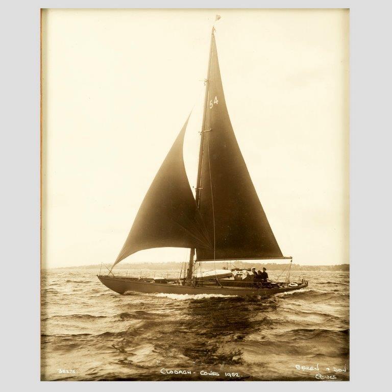 An original Photographic print of the Bermudian yacht Clodagh on starboard tack in the Solent.

The image is signed Beken and son Cowes. CLODAGHH COWES 1952 no 3223.

William Umpleby Kirk (1843–1928) was a pioneer photographer of the late