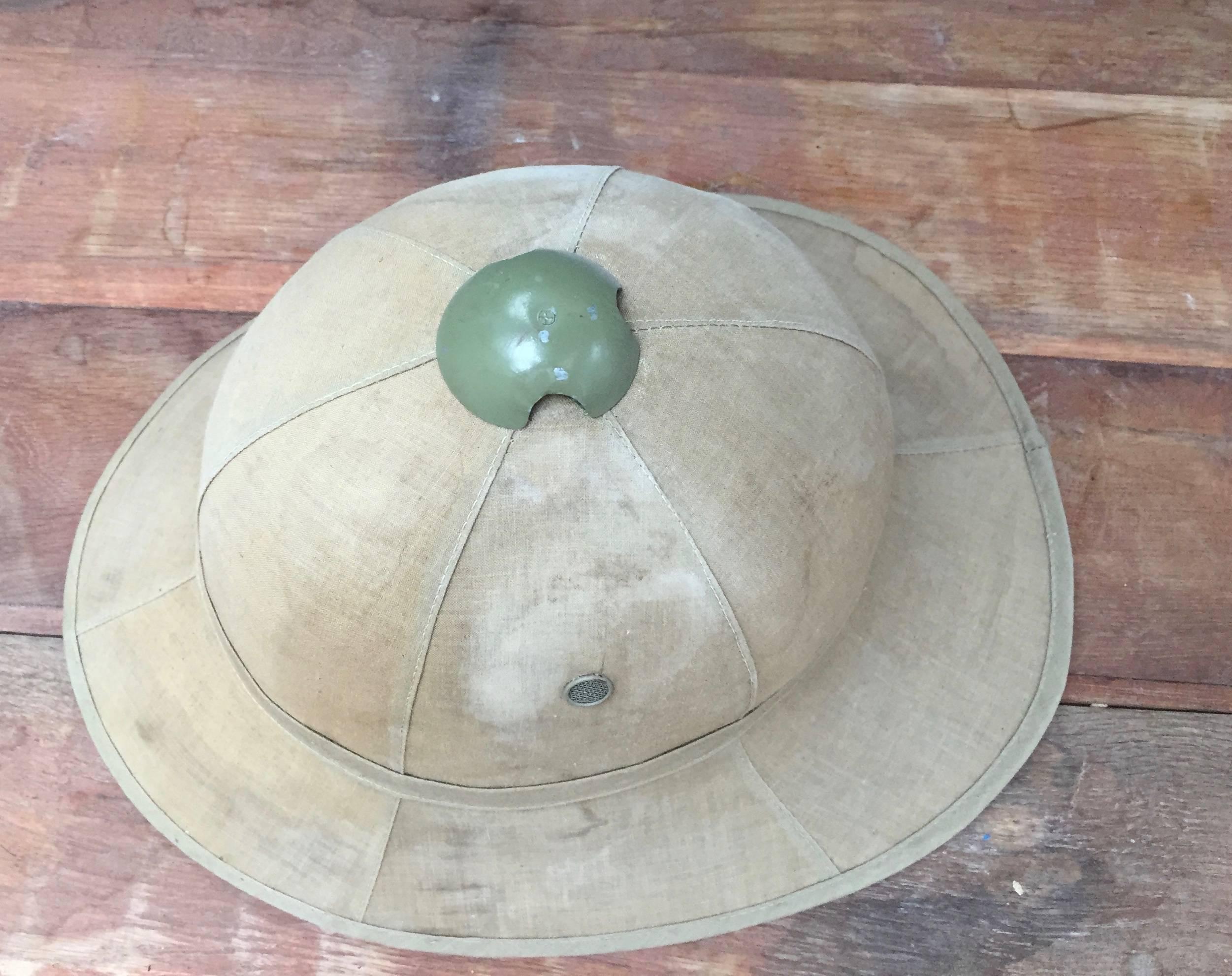 Wolseley model pith helmet used in the Belgian Congo in the 1940s. The Wolseley model was adopted by the Belgian troops from WWI until 1960 when Belgium left the Congo. Made of thin cork, the hats were soaked in water to provide cooling throughout