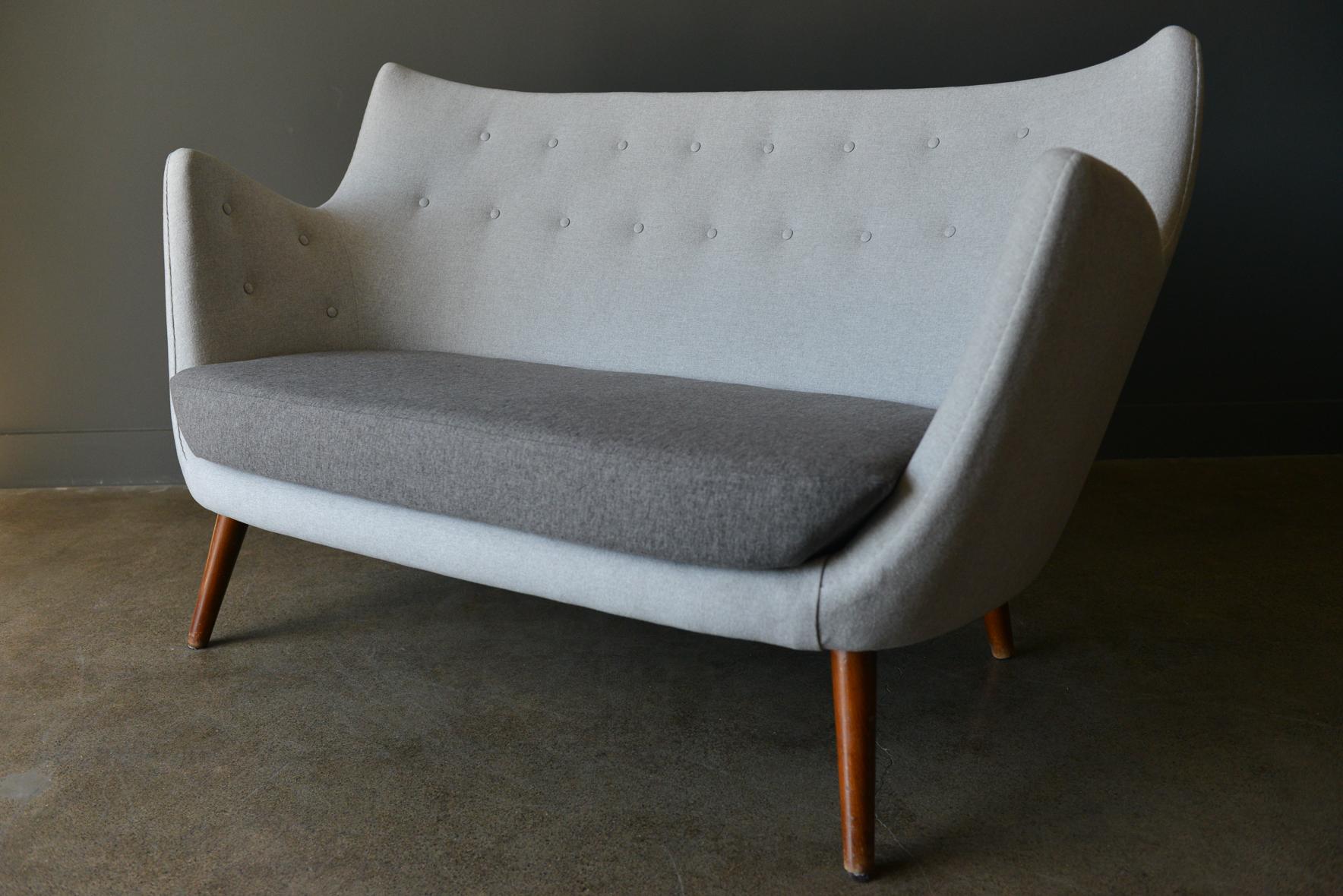 Original poet sofa by Finn Juhl, circa 1941. Original vintage poet sofa first designed in 1941 by Finn Juhl. Meticulously restored to exacting standards with handstitched seams and beautiful, soft wool blend contrasting color block design.