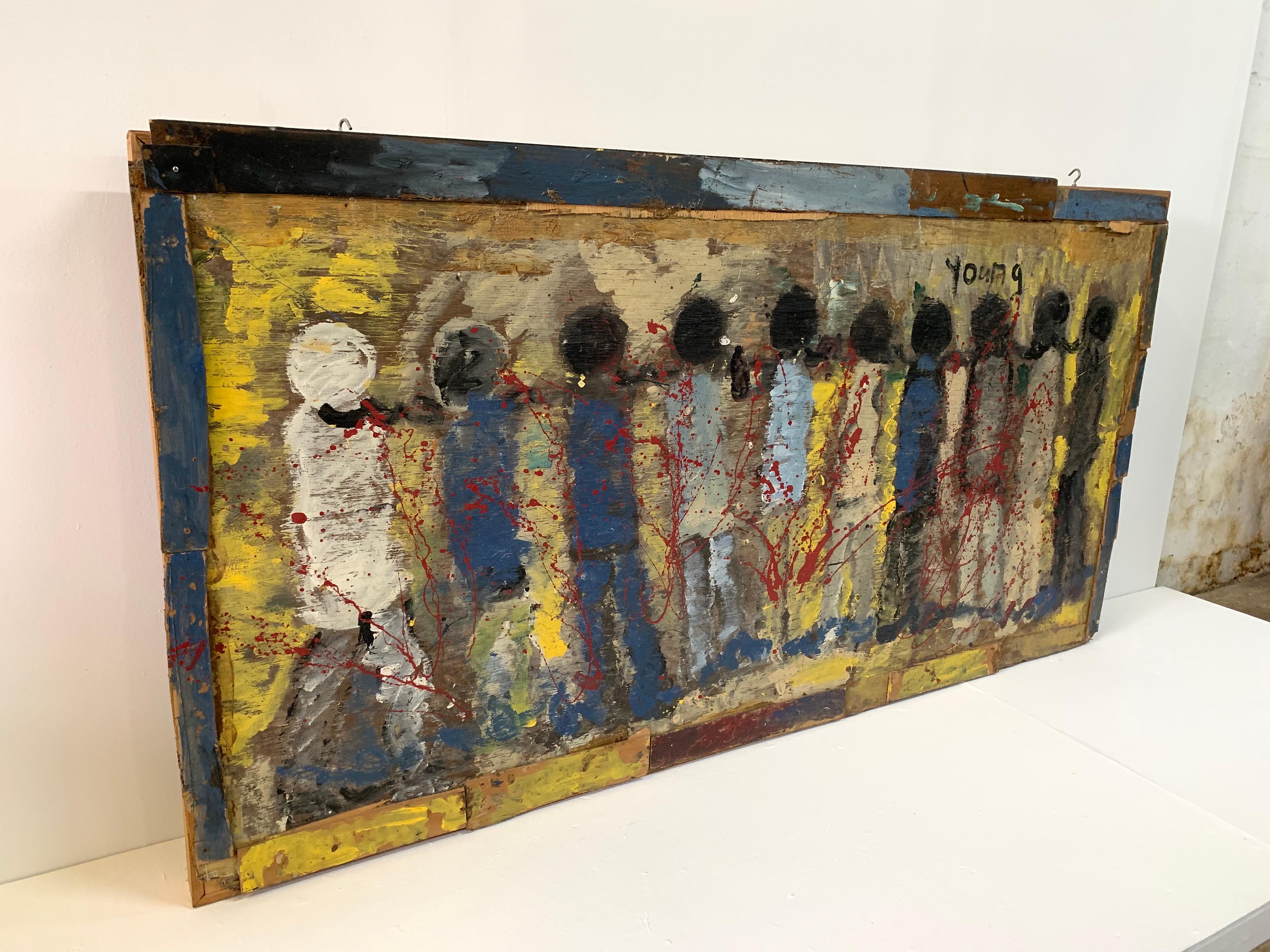 Abstract mixed-media work by artist Purvis Young. Folk Art portraying a very powerful scene of chained figures. The work depicting modern slavery is painted in vivid ochre, red, blue, white and black. Framed by the artist with found wood. The 1980