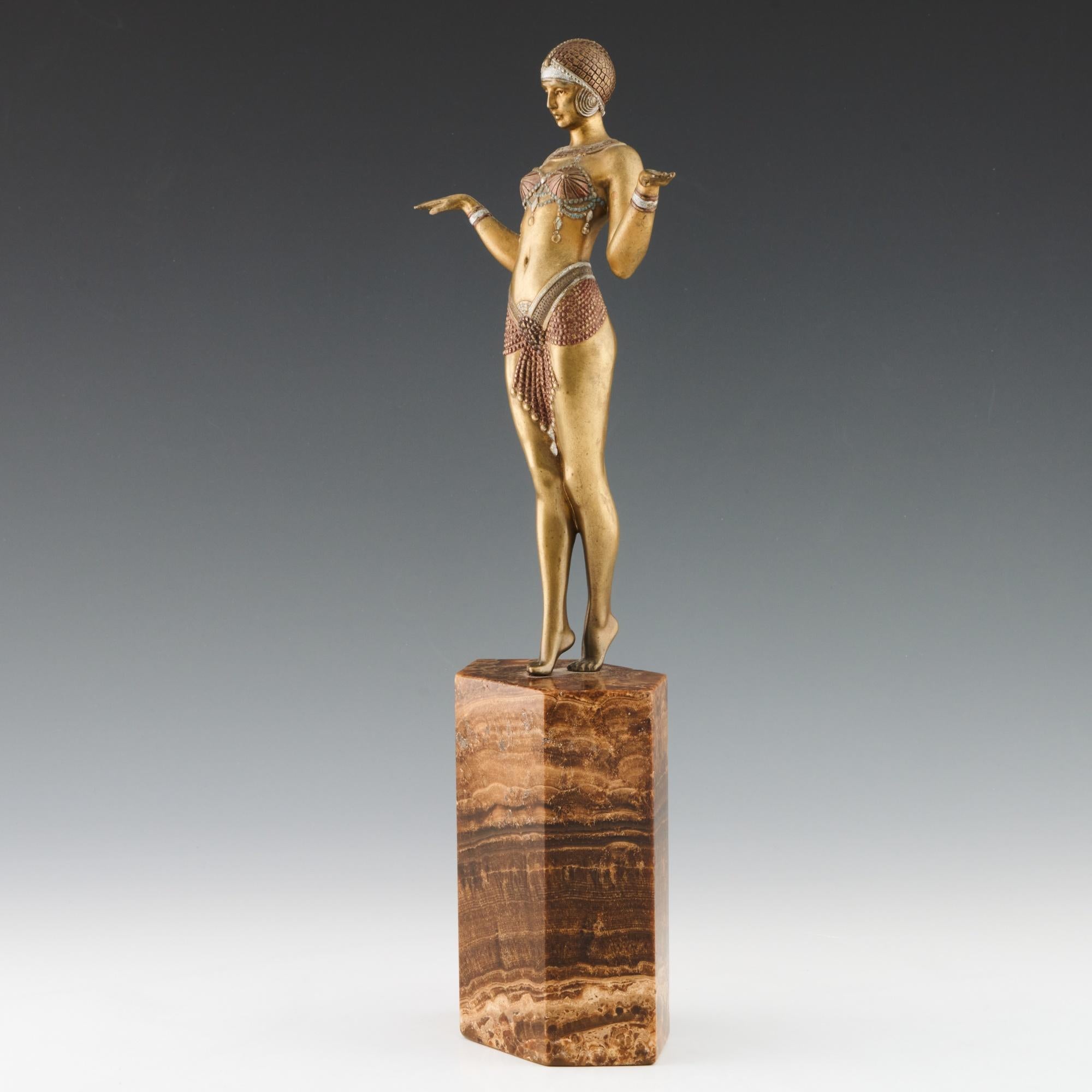 'Theban Dancer' Art Deco cold painted gilt bronze figure by Demetre Chiparus (1886-1947). An elegant dancer dressed in scantily clad theatrical costume with her elbows tucked to her waist and arms in playful pose. Excellent hand finished detail and