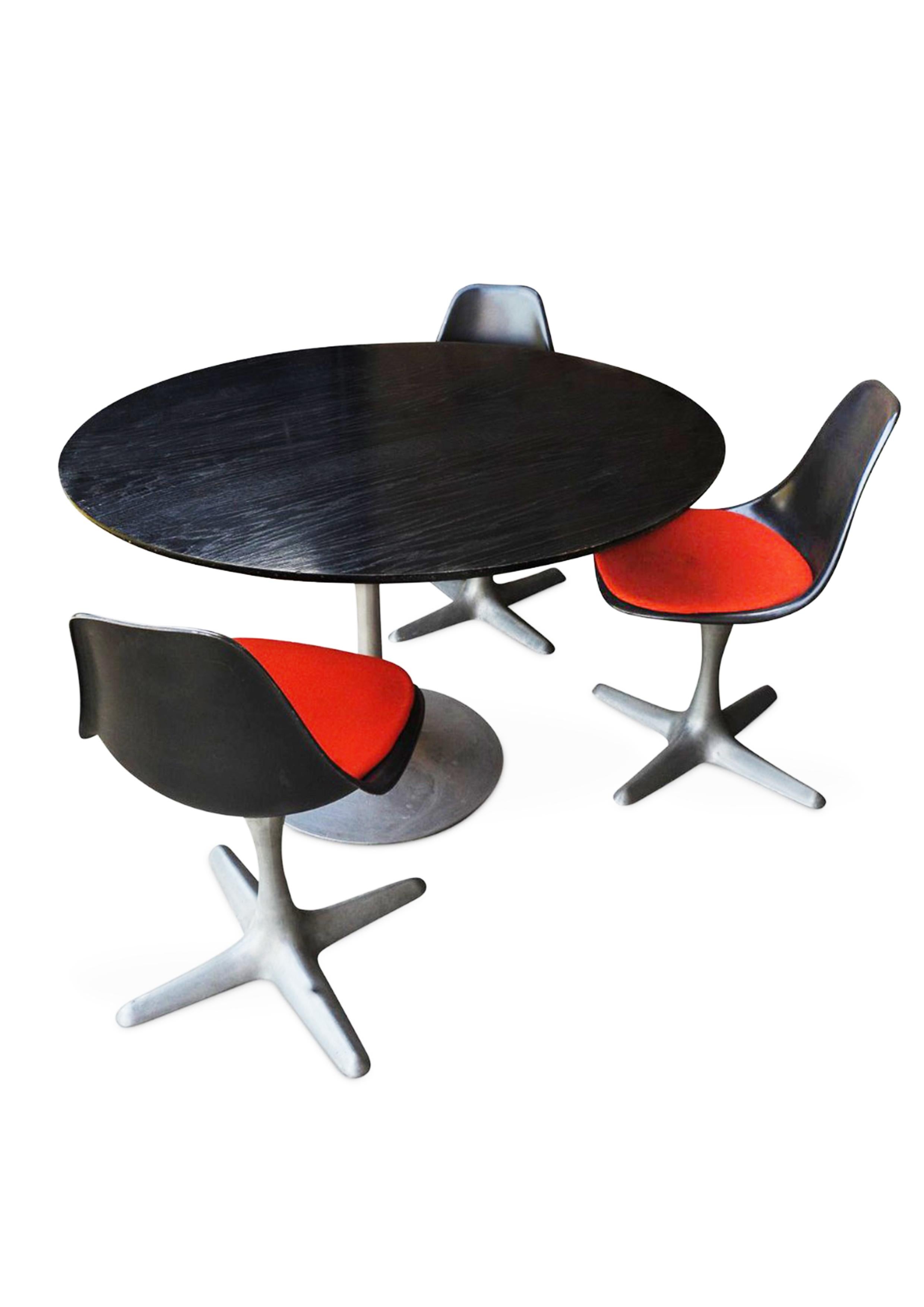 An Original & Rare Black Ash & Aluminium Arkana Circular Dining Table
With Three Black & Orange Matching Tulip Model 115 Dining Chairs 

Engraved with makers mark to base of chairs legs.

Inspired by the Tulip Table by designer Eero Saarinen, the