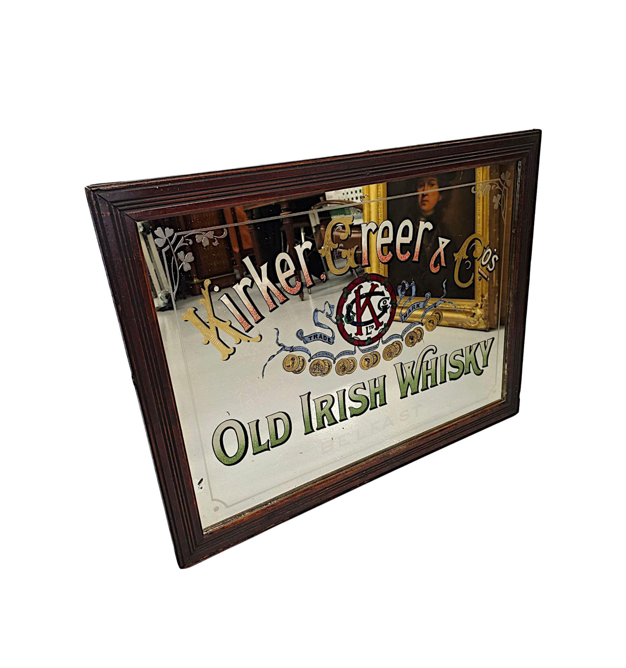 An original and rare Irish early 20th Century 'Kirker, Greer and Co. Old Irish Whiskey' advertising mirror.  The mirror glass plate of rectangular form is decorated with stunning Verre églomisé advertising 'Kirker, Greer & Co.'s Old Irish Whiskey'