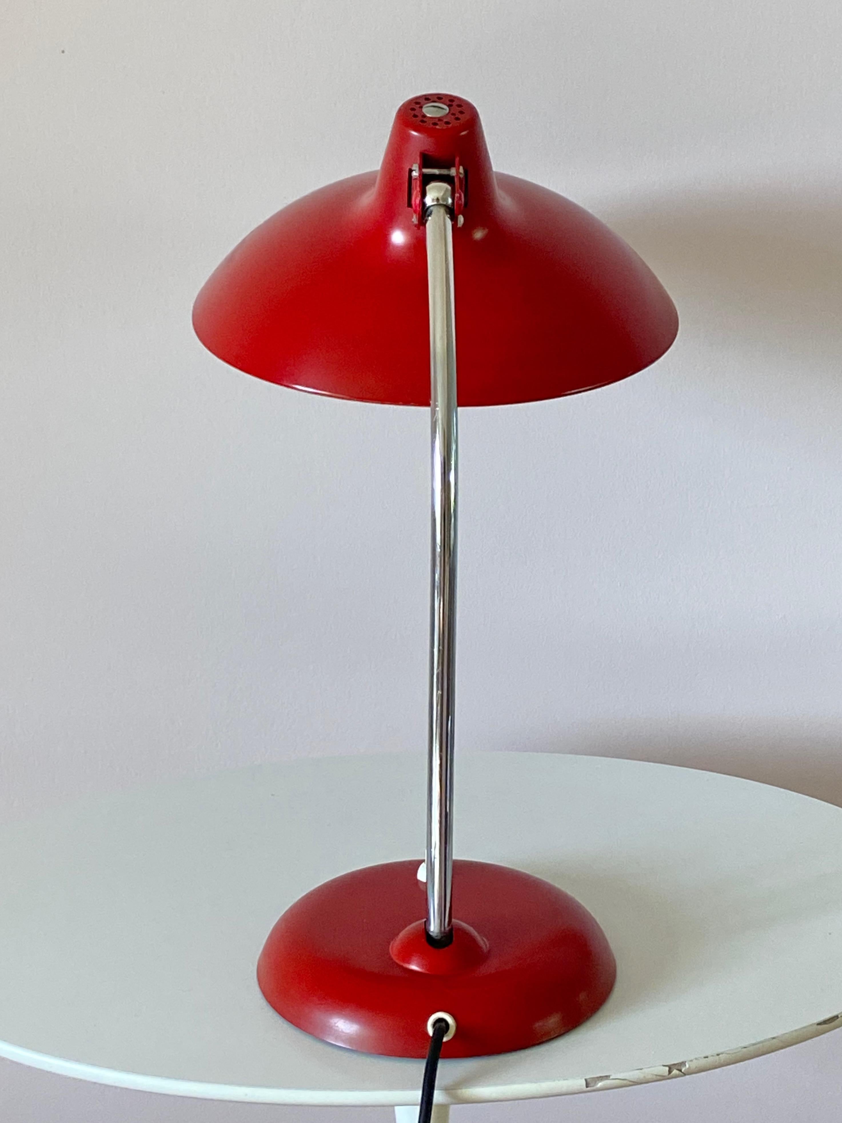 Original red Christian dell desk lamp model 6786 for Kaiser Idell, Germany. Chromed arm and shade  adjustable. With E26/27 Edison screw socket. Nice condition and ready to use with 110 and 250V.
No repaint, one bigger scratch at the shade (see