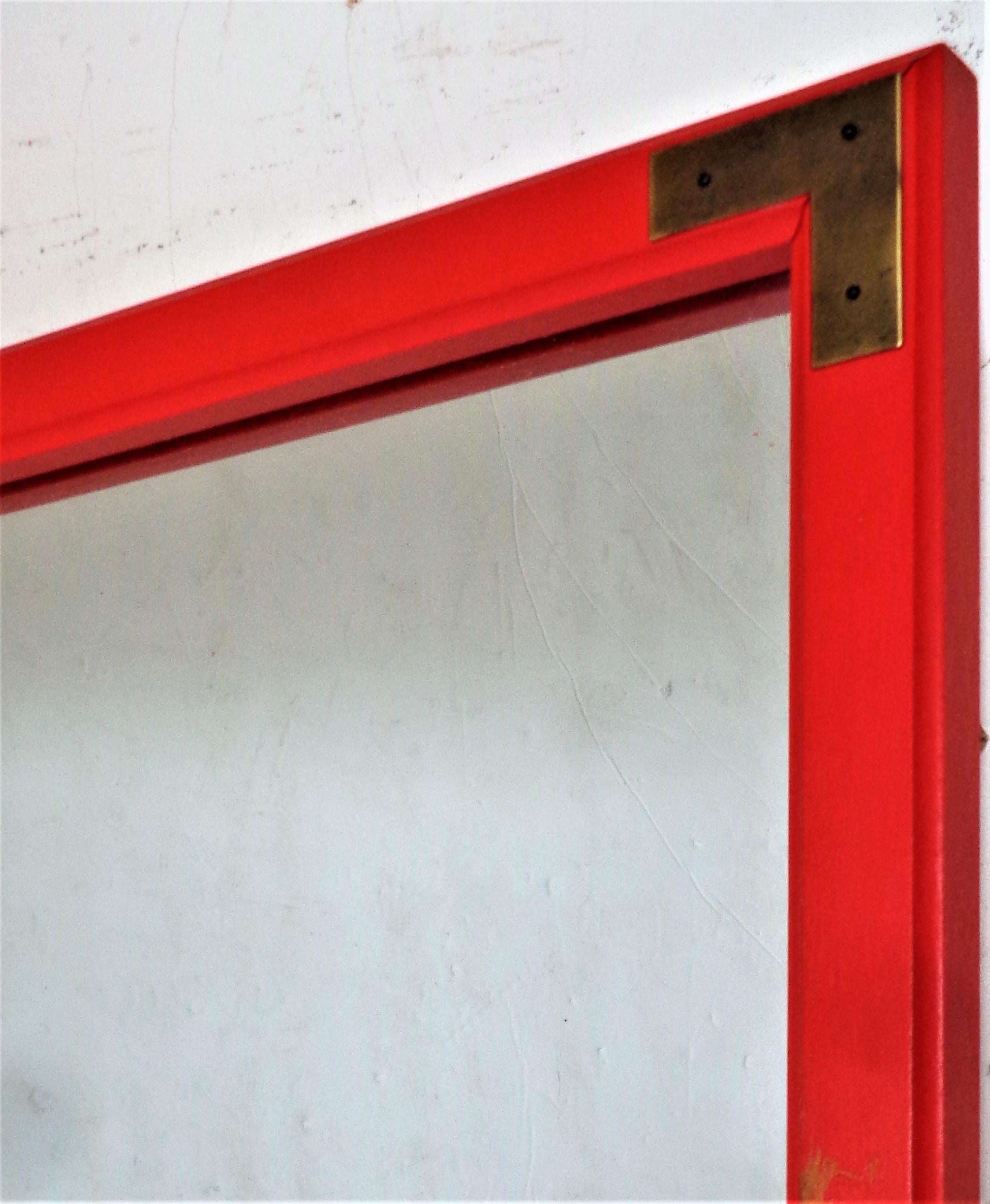 Rectangular wall mirror in the Campaign style with brass decorated corners and the original rich red orange painted factory finish. Circa 1970 - 1980. Great looking. Look at all pictures and read condition report in comment section.