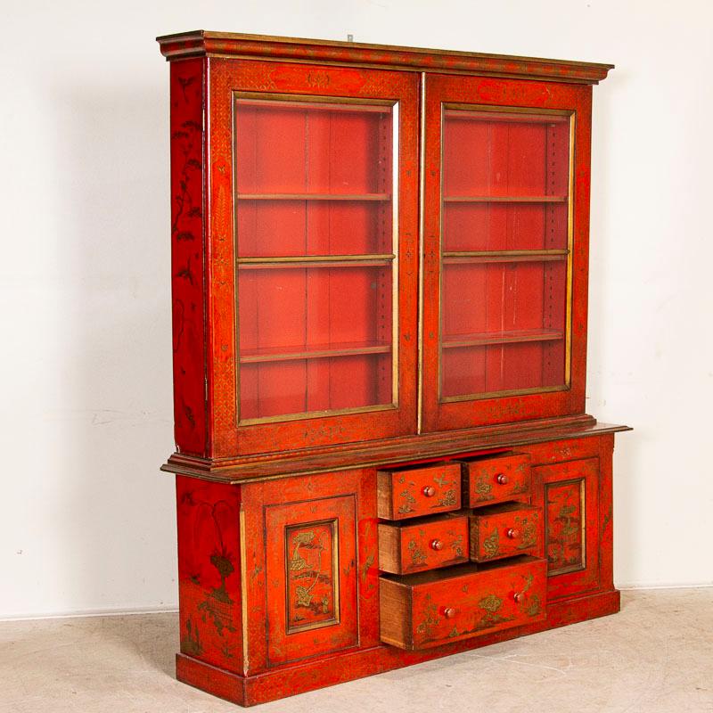 red bookcase with glass doors