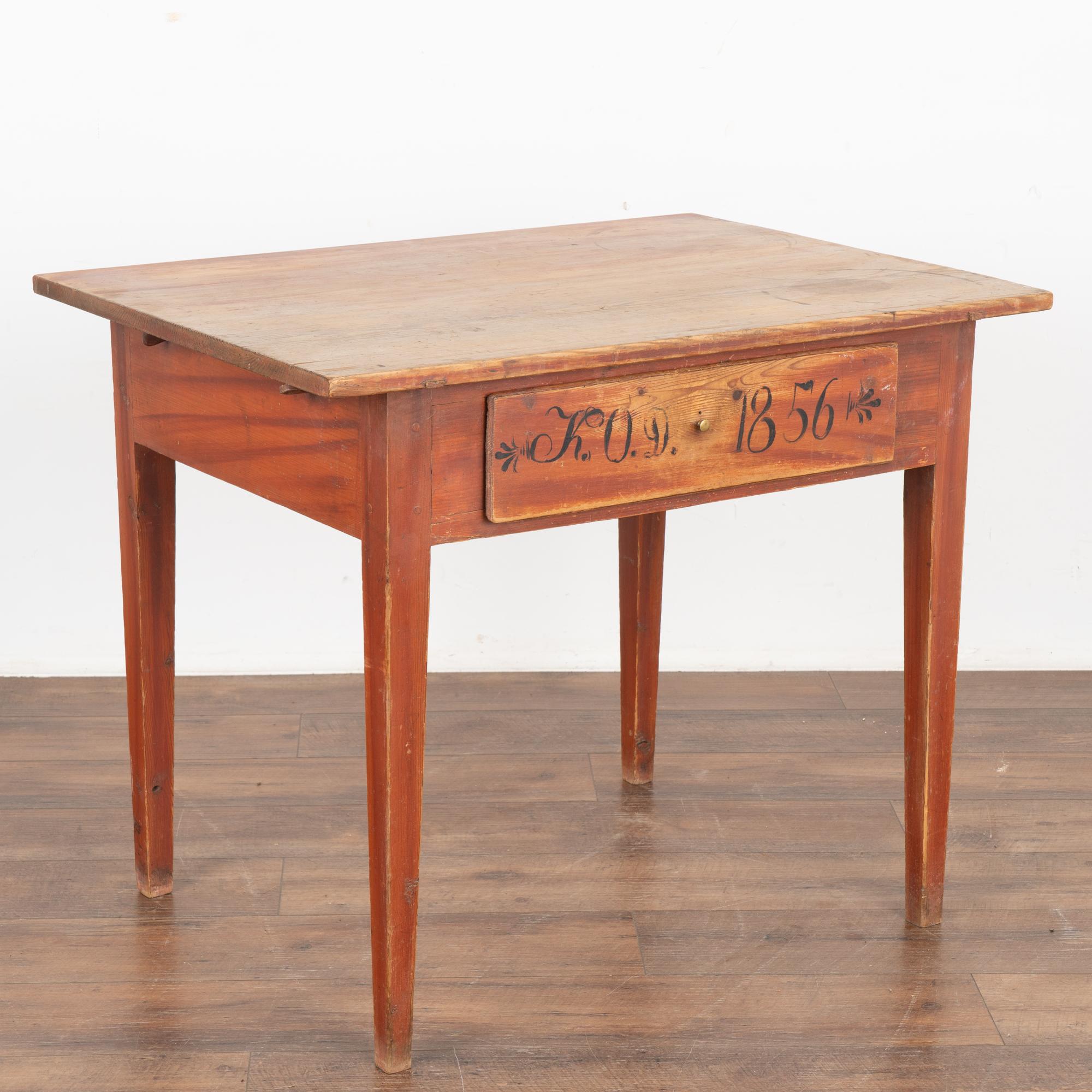 This delightful pine side table comes from the Swedish countryside and still maintains the original faux wood painted finish in brick red.
The single drawer has monogram of K.O.D. and date of 1856 which indicate it may have served as a wedding