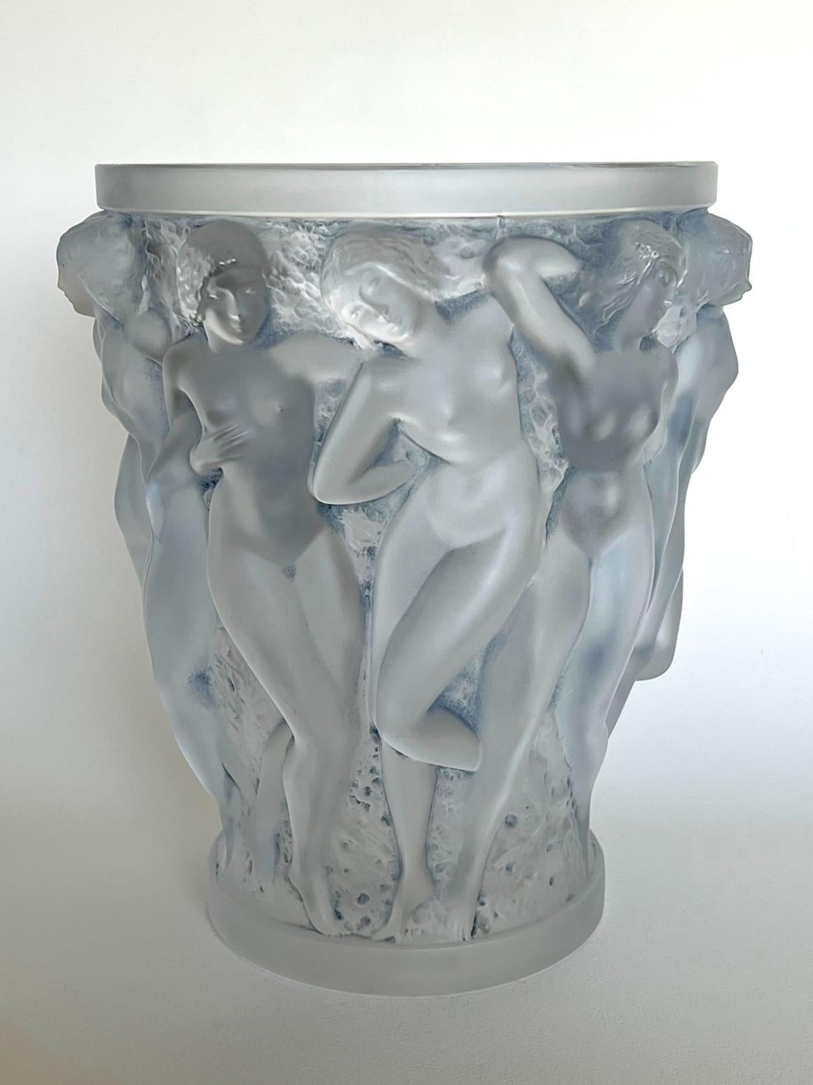 Introduced in 1927, the 'Bacchantes' vase has become an iconic design in the repertoire of one of France's leading exponents of Art Déco.
This vase is of frosted 'demi-cristal' with traces of the original blue enamel patina. Moulded in relief with a