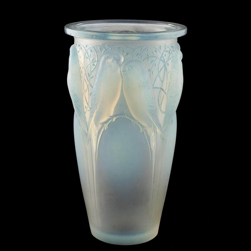 Ceylan, a frosted and opalescent glass vase. Hand etched R Lalique underside.  Excellent opalescence with love birds perched on blue opalescent branches.

René Jules Lalique (French, 1860–1945) was a renowned jeweller and master glassmaker. As one