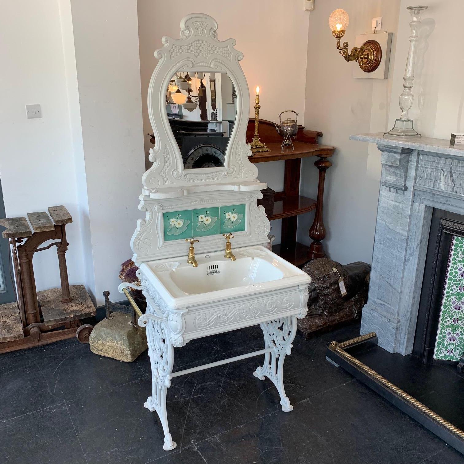 Edwardian cast iron wash Stand with tiled and mirrored splash-back, complete with original basin, unlacquered taps and brass towel rail which can be positioned either side of the Stand, circa 1905. The cast iron has been primed so it can be painted