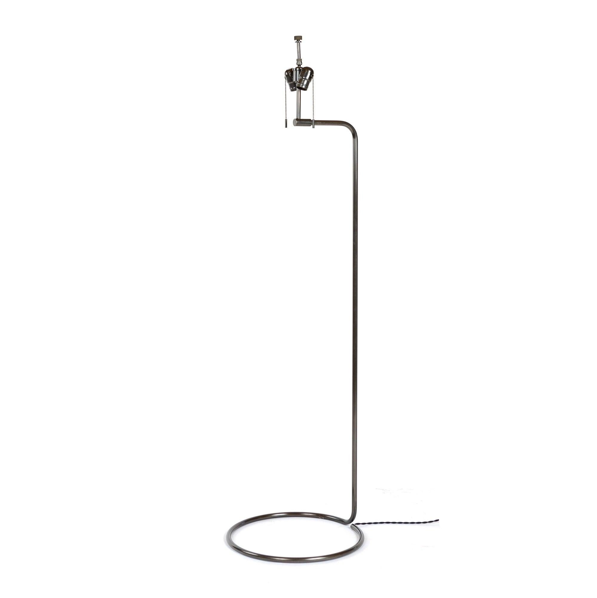 A spare, sinuous floor lamp made from a continuous coil of thinly gauged blackened bronze tubing. Available in polished, brushed, patinated or blackened finishes. Lead time 6-8 weeks. Made by the Workshop in Brooklyn, NY.??Shade sold separately.