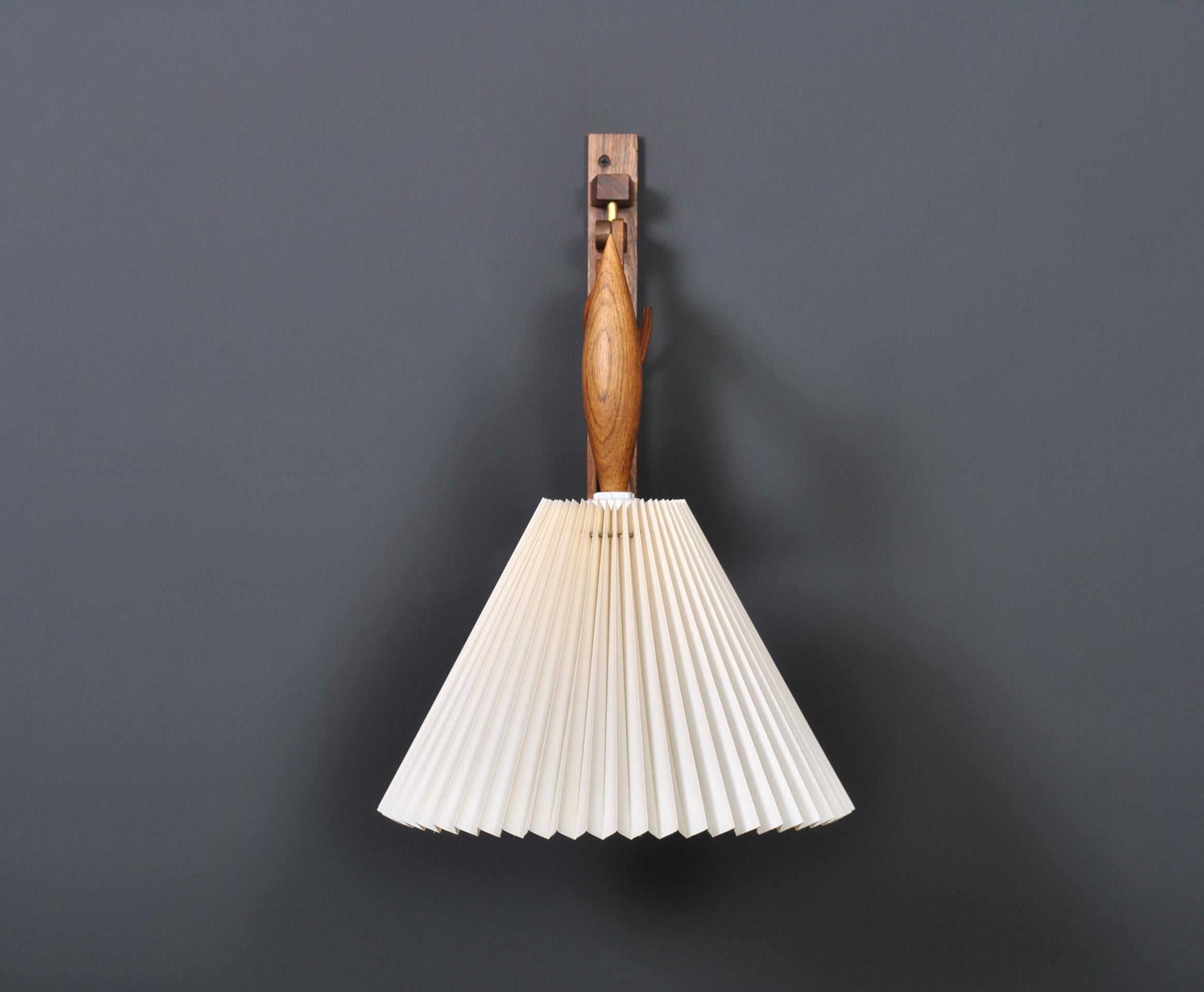 An original Le Klint Scissor wall lamp. Produced by Le Klint circa 1950, Denmark. Beautiful rosewood construction. Adjustable scissor action and slight angle adjustable lamp head. Can be fitted to existing wall lighting circuit or with cable to
