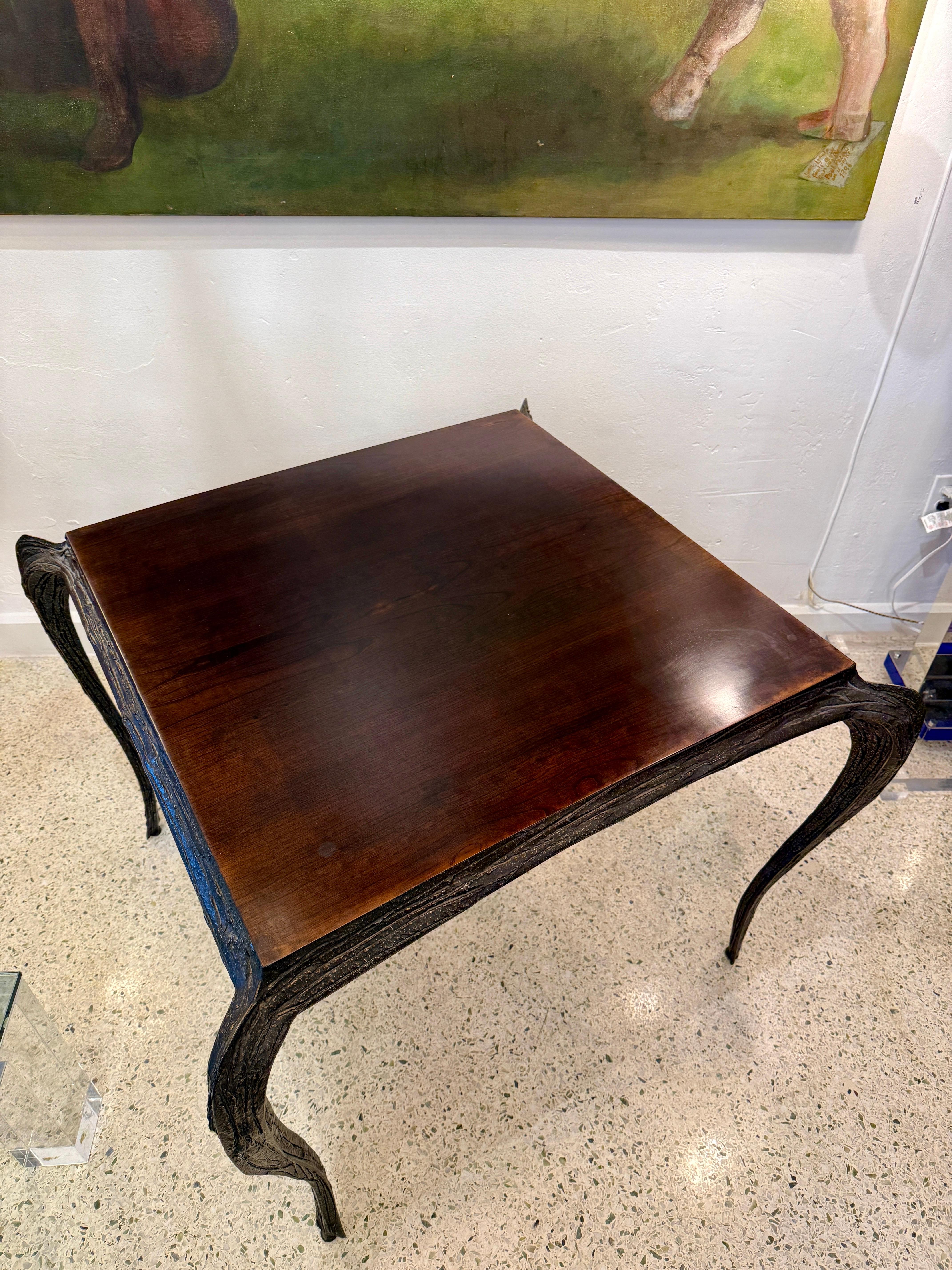 This is a Paul Evans brutalist bronzed resin over steel table with wood veneer top. 

Provenance reference: Paul Evans Designer & Sculptor, Jeffrey Head, pg. 91.