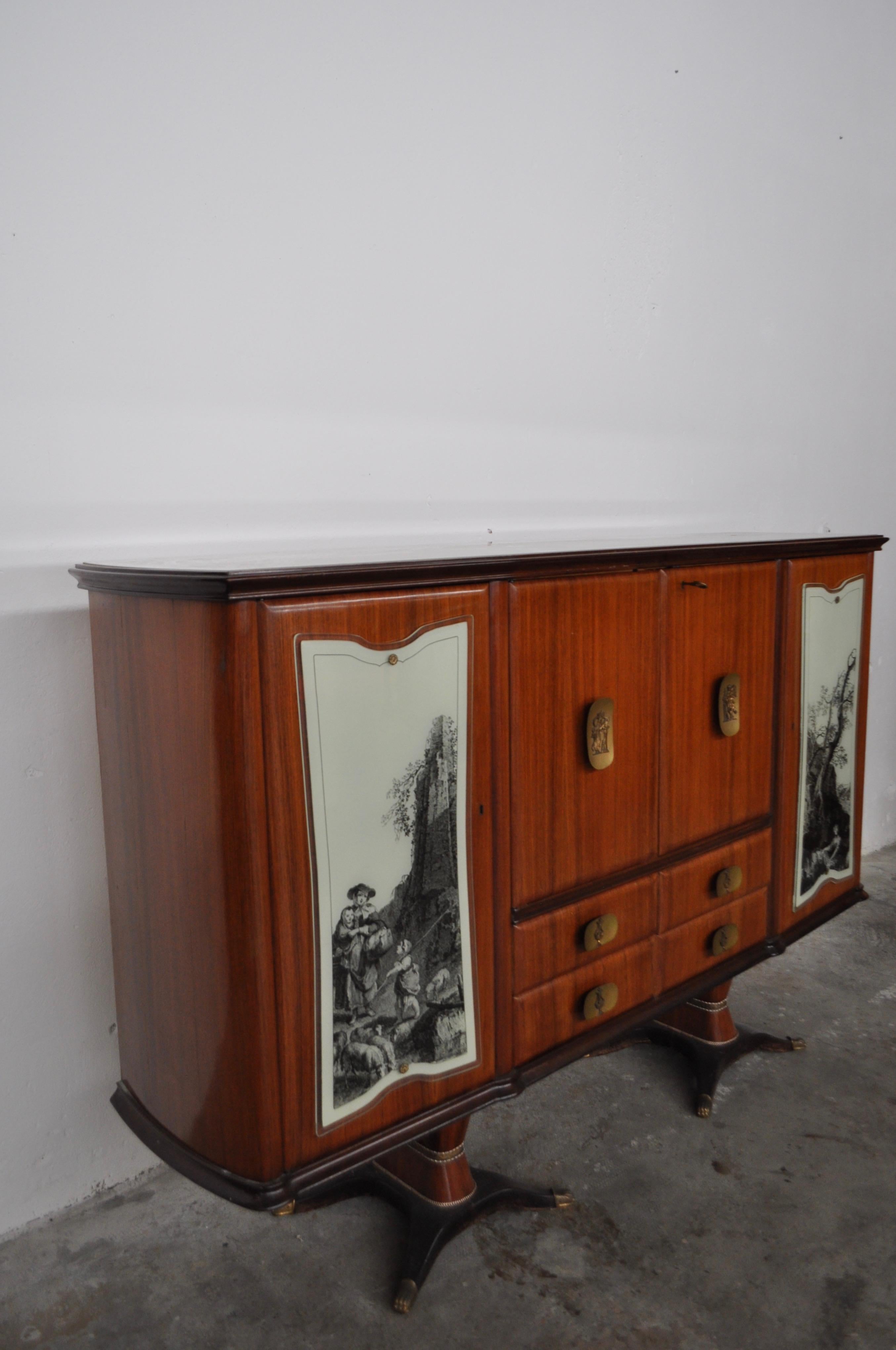 Mahogany, pear tree, brass, glass top sideboard with doors with allegorical drawings and internal lightning by F.lli Rigamonti, Italy, 1950s.