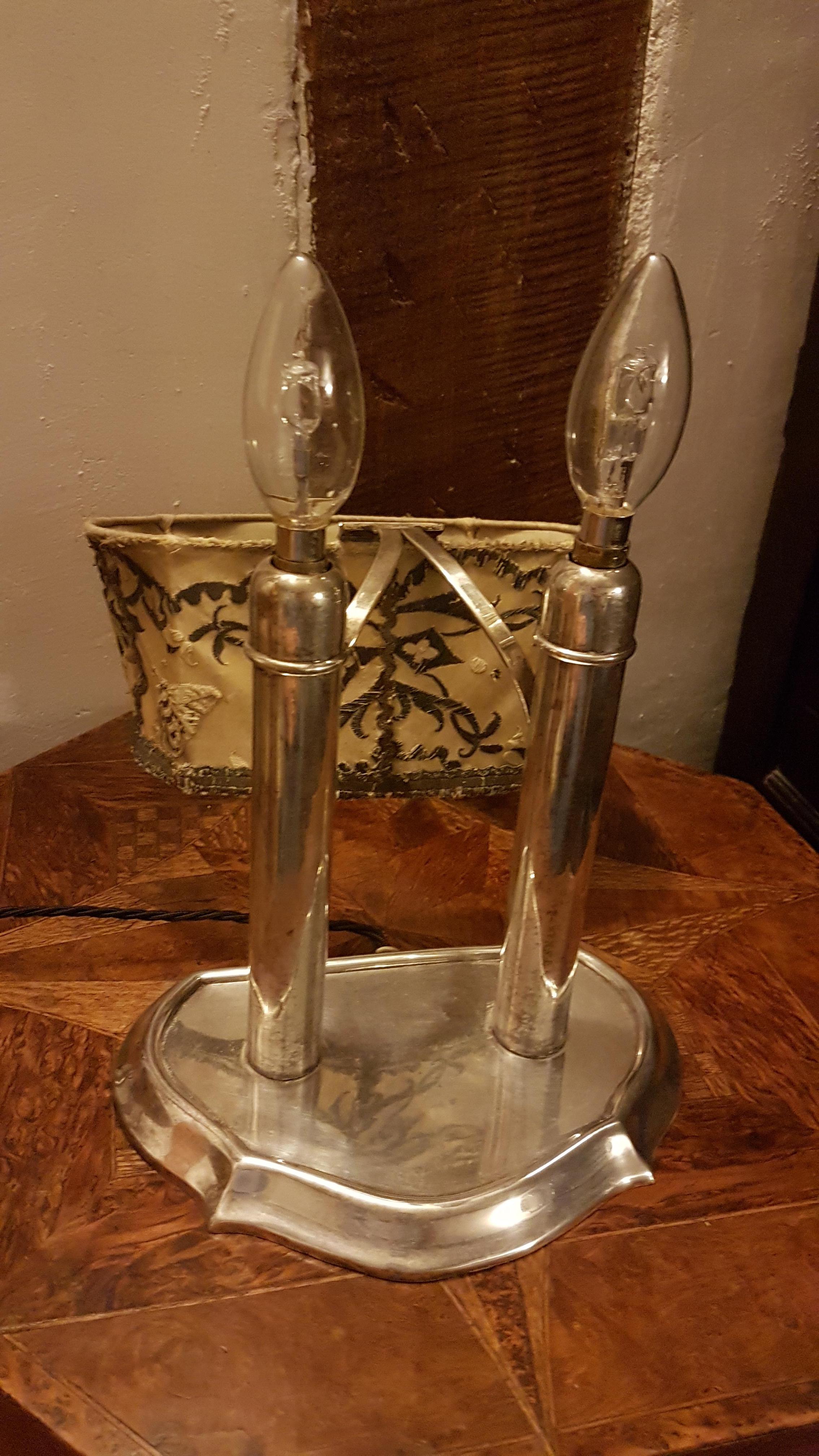 A very nice original, 1930s silver plated double students lamp that has similar form to that of the spring loaded students candle lights. The silver plate has a nice patina to it with areas of tarnish. It has been rewired to suit UK's 240v.

The
