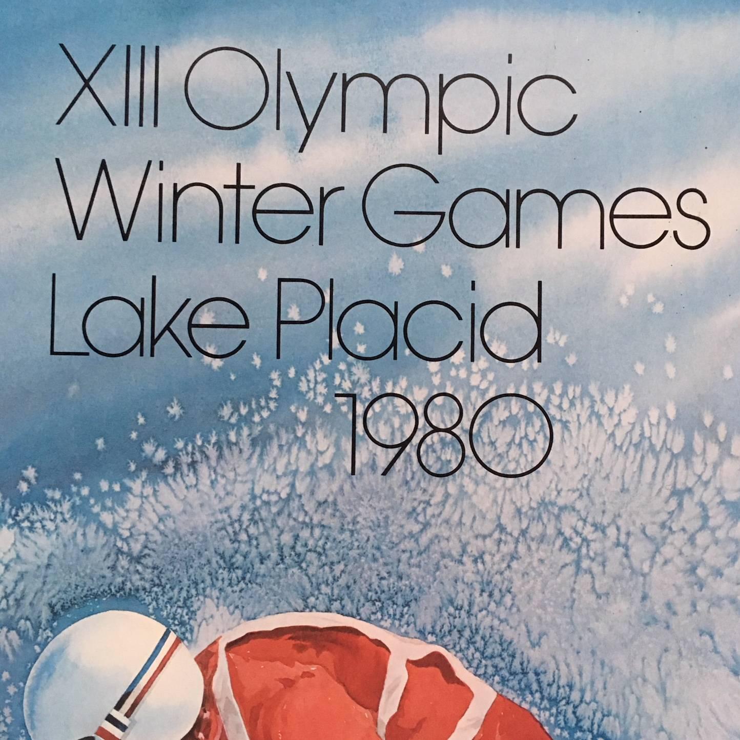 Original skiing poster from the 1980 Lake Placid Olympics, in excellent color and condition as issued on fibercore, with a series of U.S Postal Stamps commemorating the Lake Placid Olympics, adhered to the poster and canceled on the day of issue.