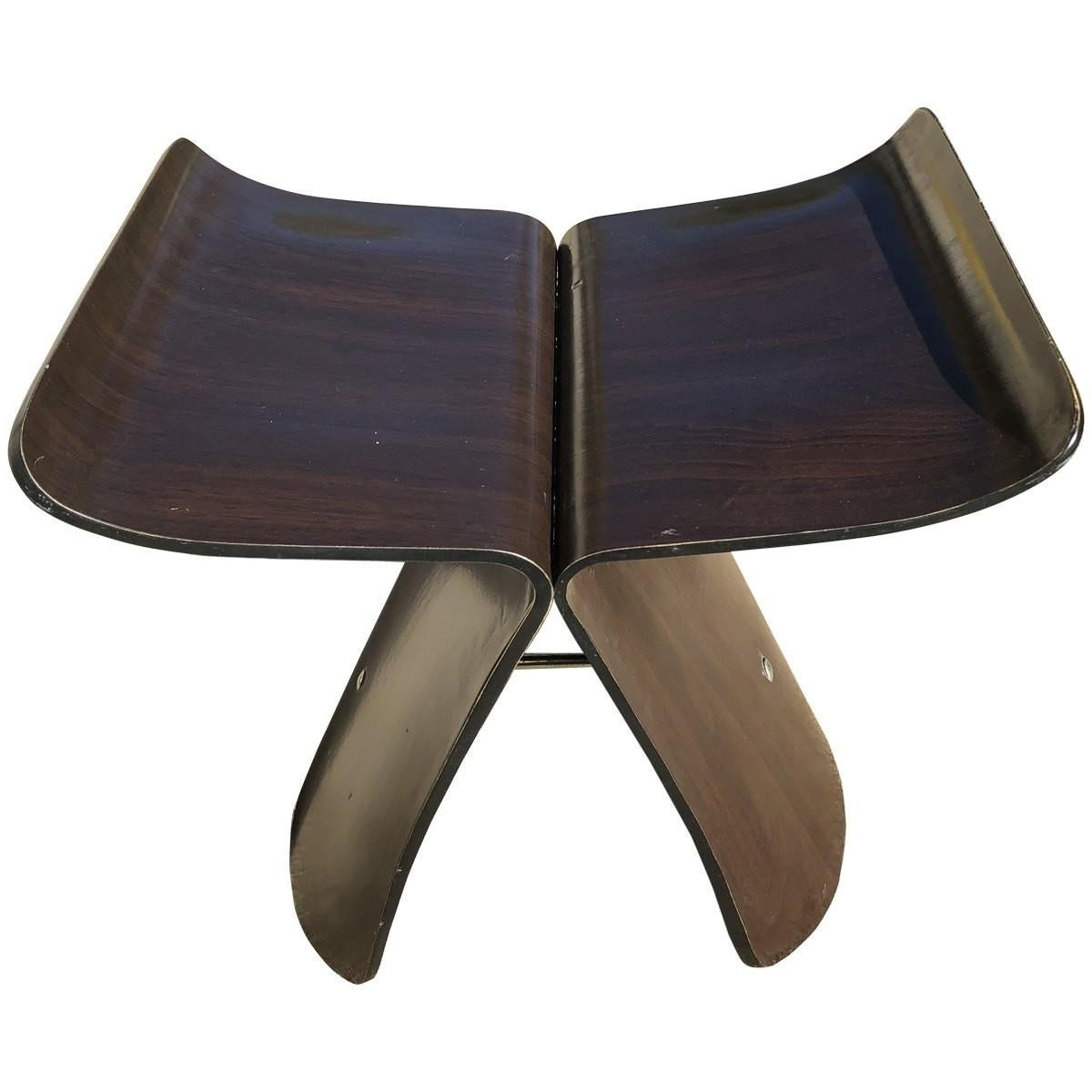Original Sori Yanagi butterfly stools. Japanese product designer Sori Yanagi created home items with a high level of modernist and minimalist elements. Yanagi designed this molded plywood butterfly stool for Tendo. It is made with a dark brown