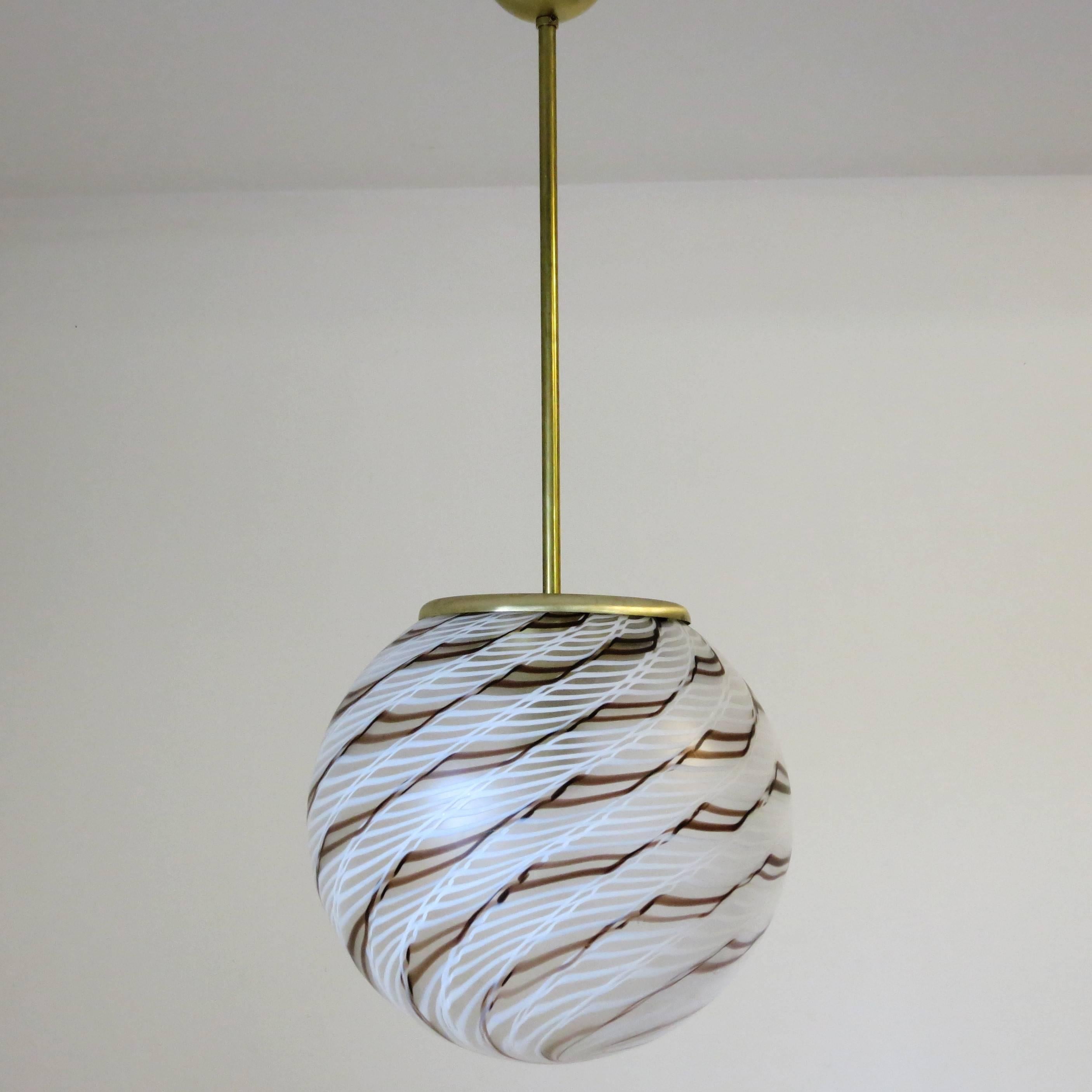 Vintage Italian pendant with frosted Murano glass globe and artistic chocolate brown and vanilla white stripes spiral design, mounted on brass hardware / Designed by La Murrina circa 1960’s
1 light / E26 or E27 type / max 60W
Diameter: 15.75 inches