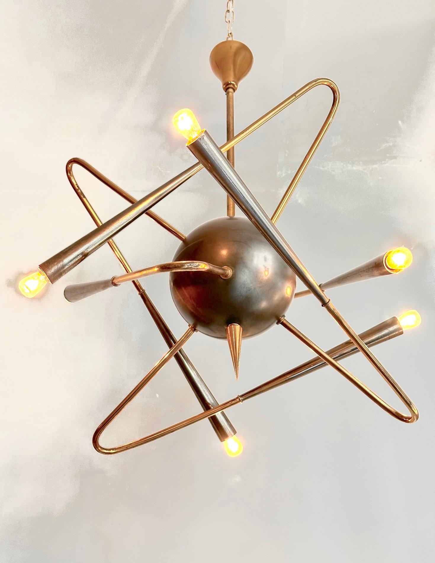 An original Stilnovo chandelier/pendant,Edited in Italy in 1950.
Original lighting feature including    six brass arms and a central medallion connected to a rigid brassro.Exquisite design.evoking a satellite shape.
Professional packing  and