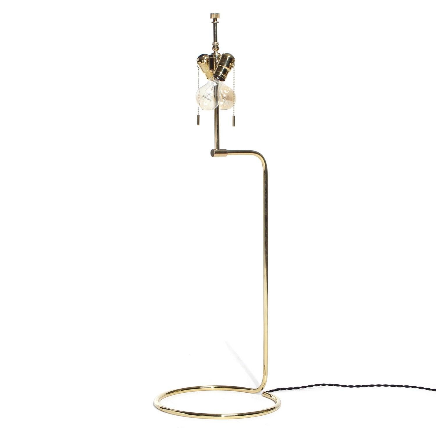 A spare, sinuous table lamp made from a continuous coil of thinly gauged bronze tubing. The ideal lamp shade stand. Available in polished, brushed, patinated or blackened finishes.