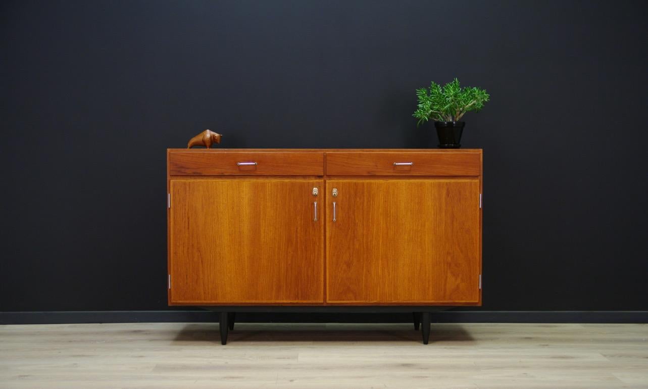 Original cabinet from the 1960s-1970s, Minimalist form - Danish design. The whole veneered with teak. Roomy interior with a shelf behind the doors. In addition, two usable drawers. No key. Preserved in good condition (scratches and small bruises) -