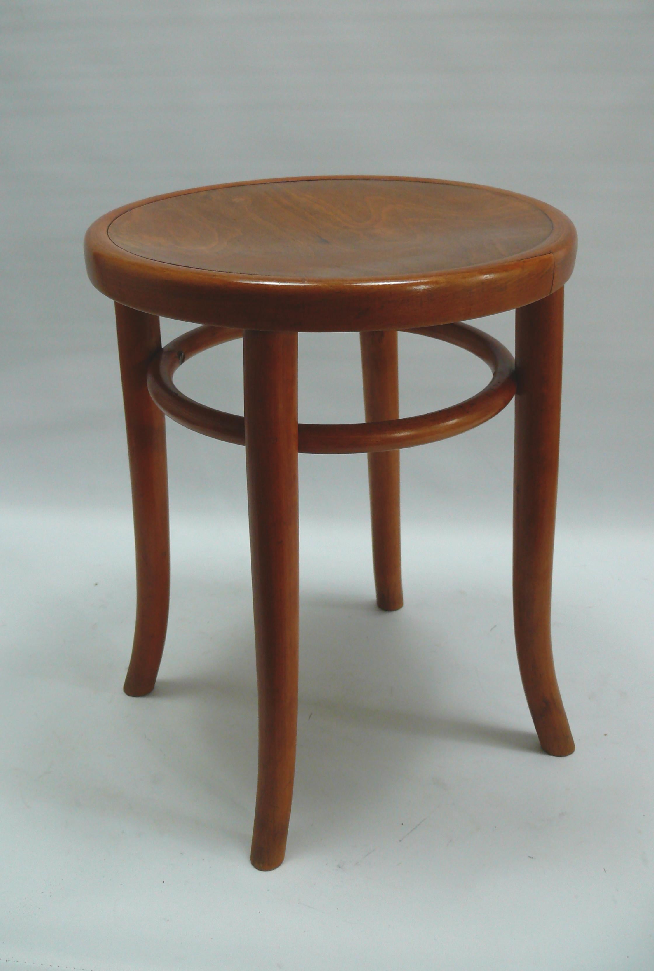 A light-colored bentwood stool by Thonet, from the mid-20th century, in very beautiful, restored condition. The stool is made of bent beechwood and has a second bentwood ring beneath the seat for stability. This construction principle was developed