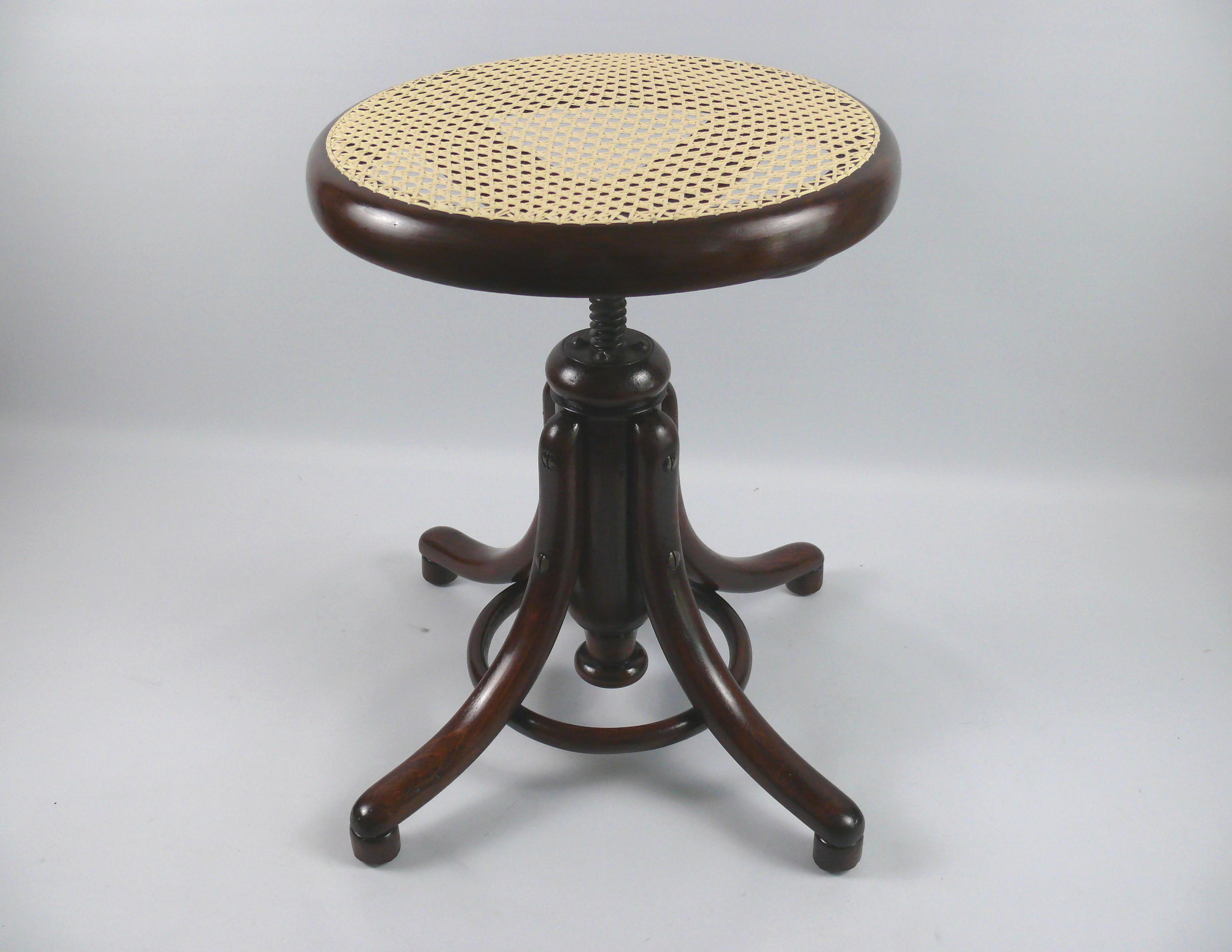 Restored swivel stool no. 1 from the traditional company Gebrüder Thonet, Vienna from the end of the 19th century. The piano stool has a frame of four steam-bent feet. The curved feet are held together by the wooden ring made of curved wood. The