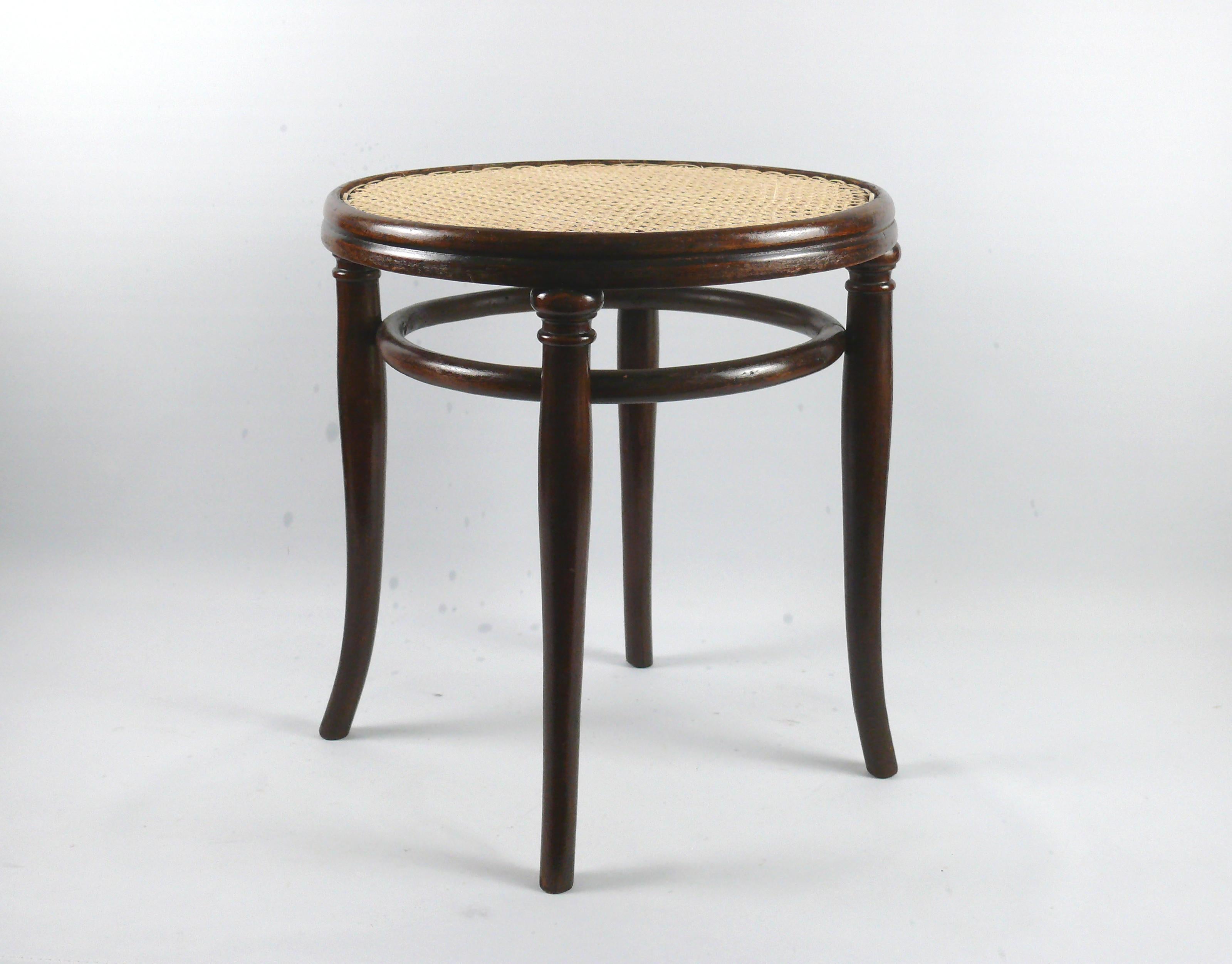 Large bentwood stool with Viennese weave from the late 19th century by the traditional company Gebrüder Thonet, Vienna. The stool is made of bent beech wood and has a second bentwood ring below the seat for stability. Michael Thonet developed this