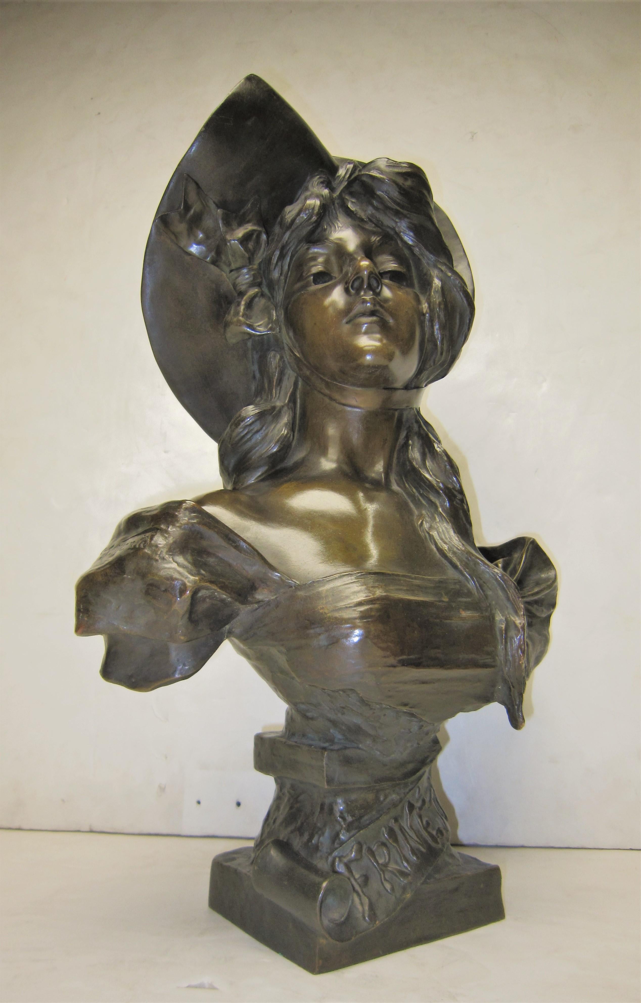 French late 19th-early 20th century highly decorative polychrome bronze statue of a young woman with chiseled features wearing a low bodice.
The Art Nouveau bust entitled “Frinette” was sculpted by Emmanuel Villanis from a live model.
Villanis, a
