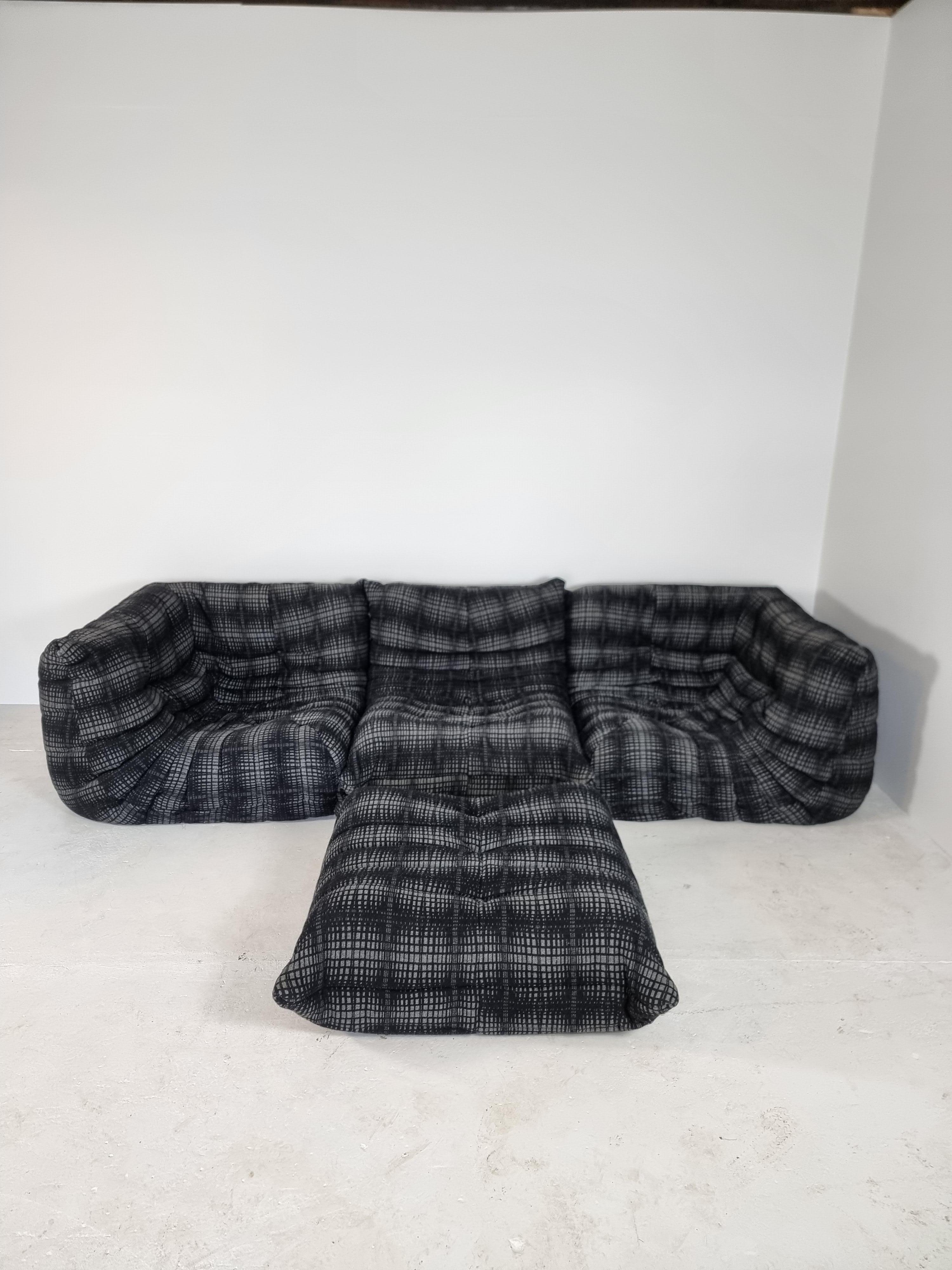 Original Ligne Roset sofa, model Togo.

Design by Michel Ducaroy.

Original wool black-grey eighties fabric.

In absolute perfect condition with original tags.
