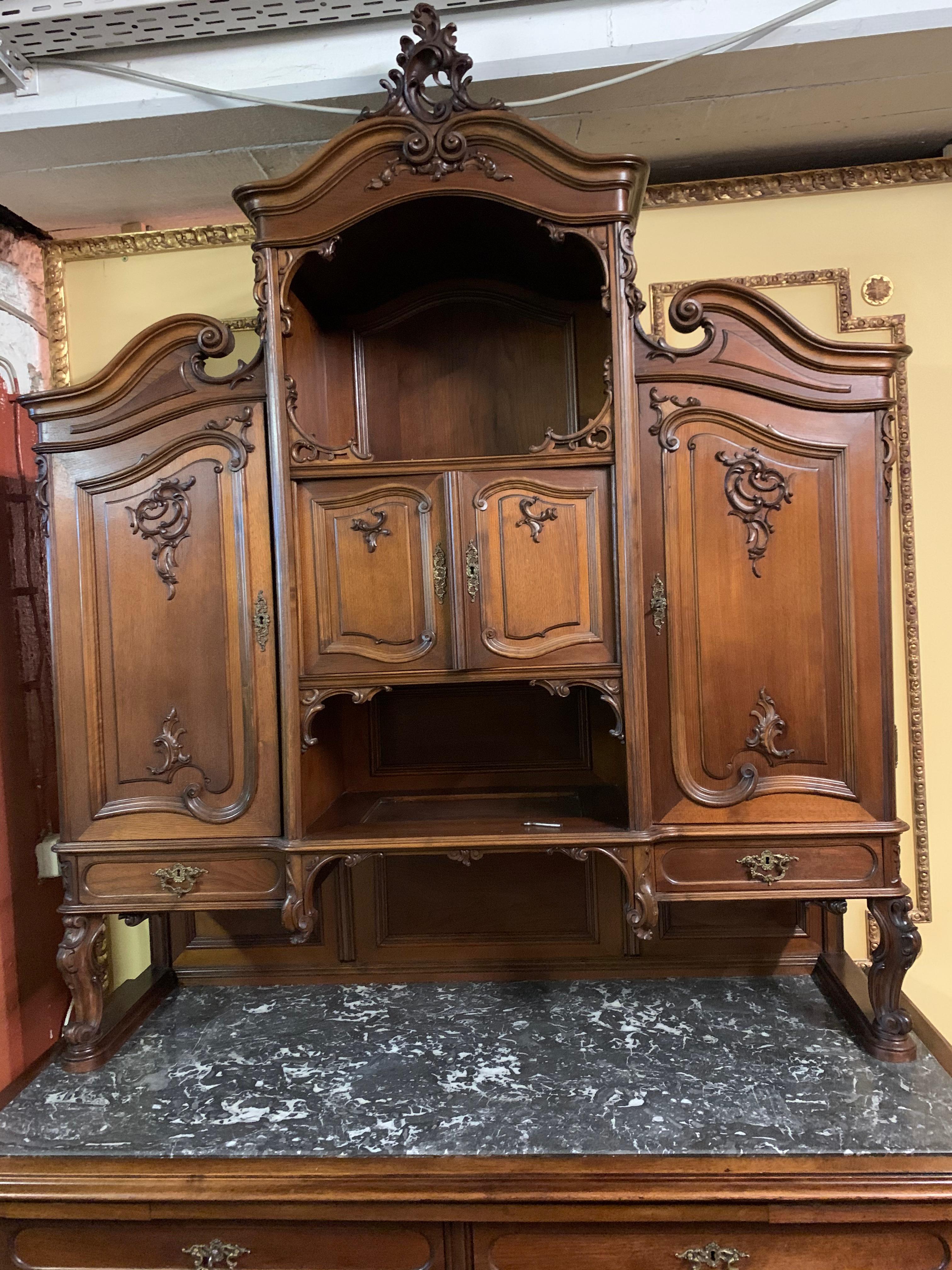 Vienna rococo buffet from the carpenter Jacob Kain`s, circa 1860.

Solid walnut and oak. Architecturally designed front. Two-door, two-drawer body on pressed ball feet. Slightly recessed attachment on a high-quality marble slab. In the front there