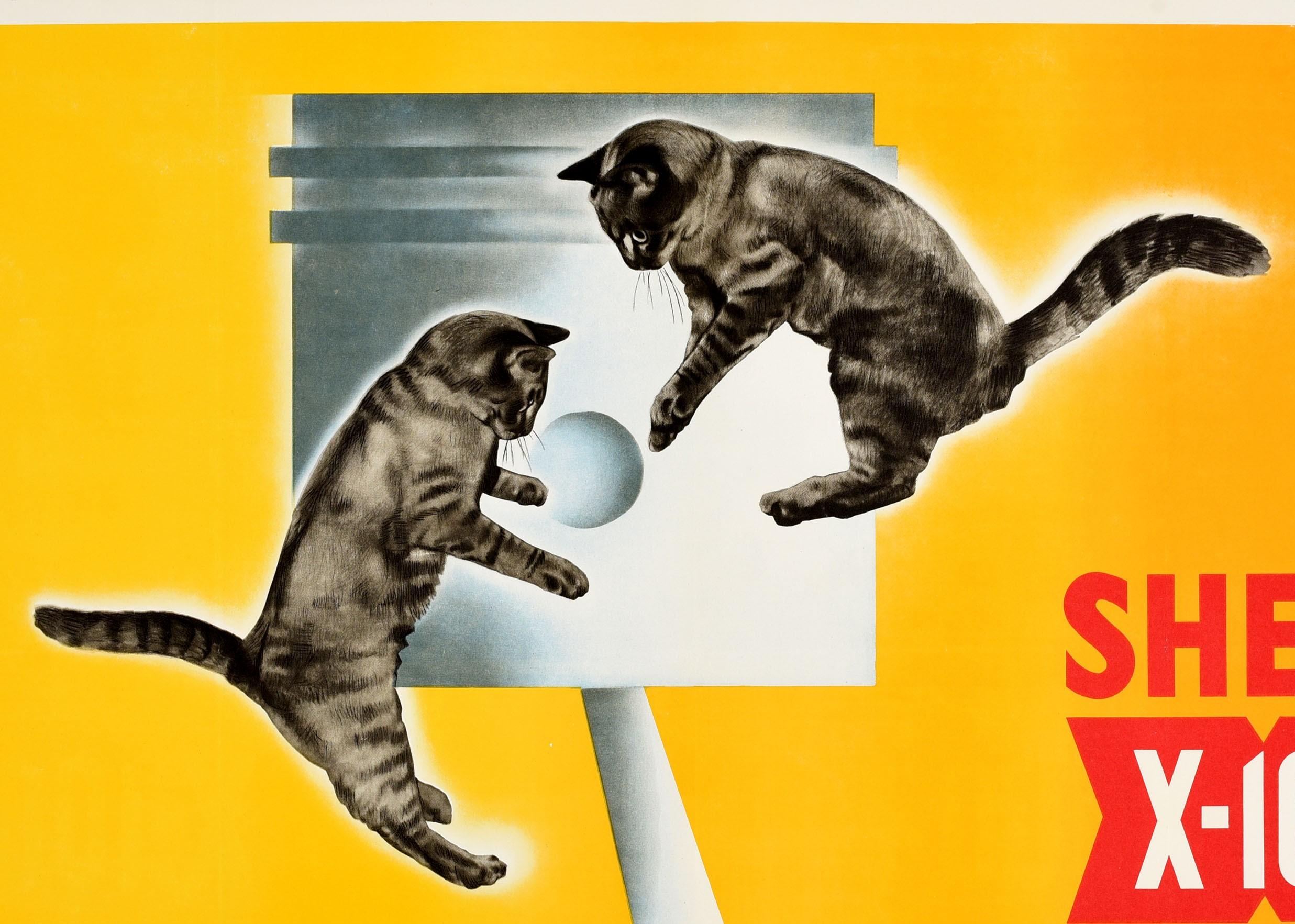 Original vintage advertising poster for Shell X-100 Motor Oil Keeps your engine in top shape / Garde votre moteur en pleine forme featuring a fun image of two cats in front of a motor as if they're playing with a ball against the yellow background.