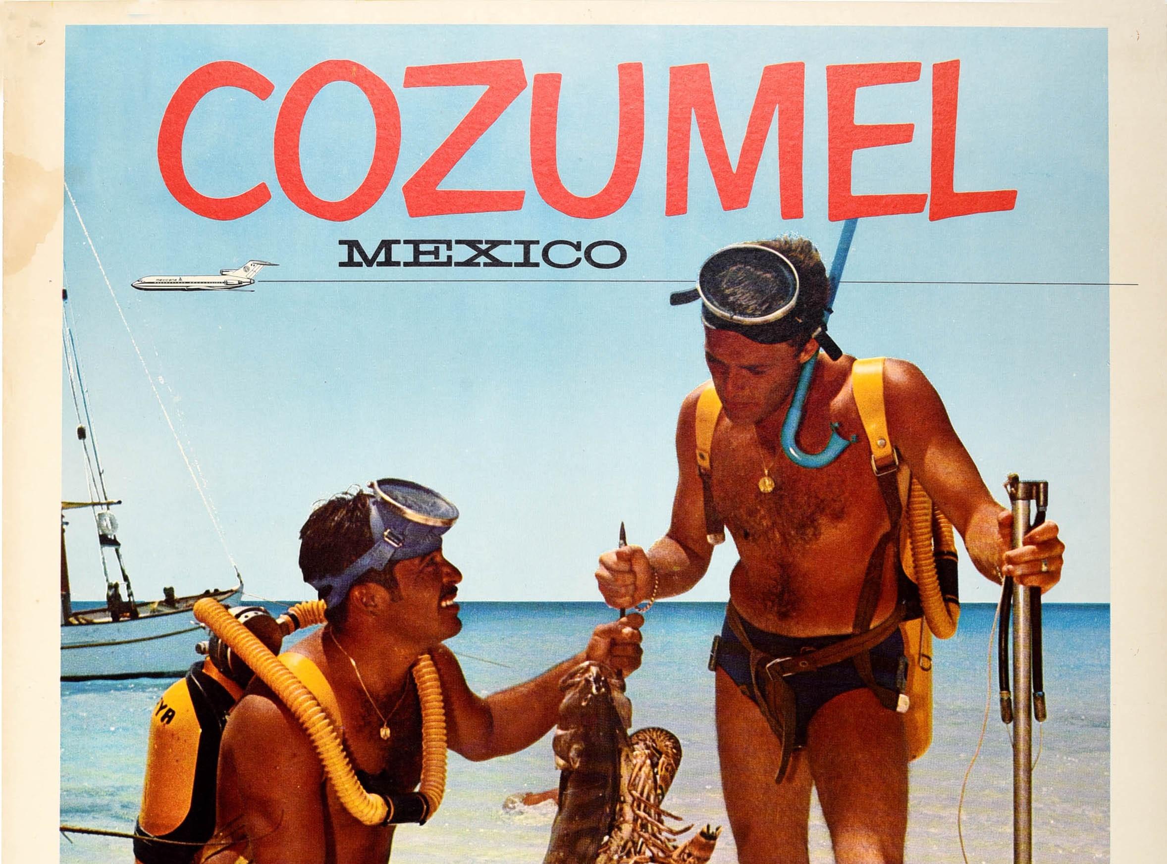 Original vintage travel poster for Cozumel Mexico issued by Mexicana airlines featuring a photo of a two scuba divers on a sandy beach with a sailing boat in the background and a stylised plane flying over the sea against the blue sky below the bold