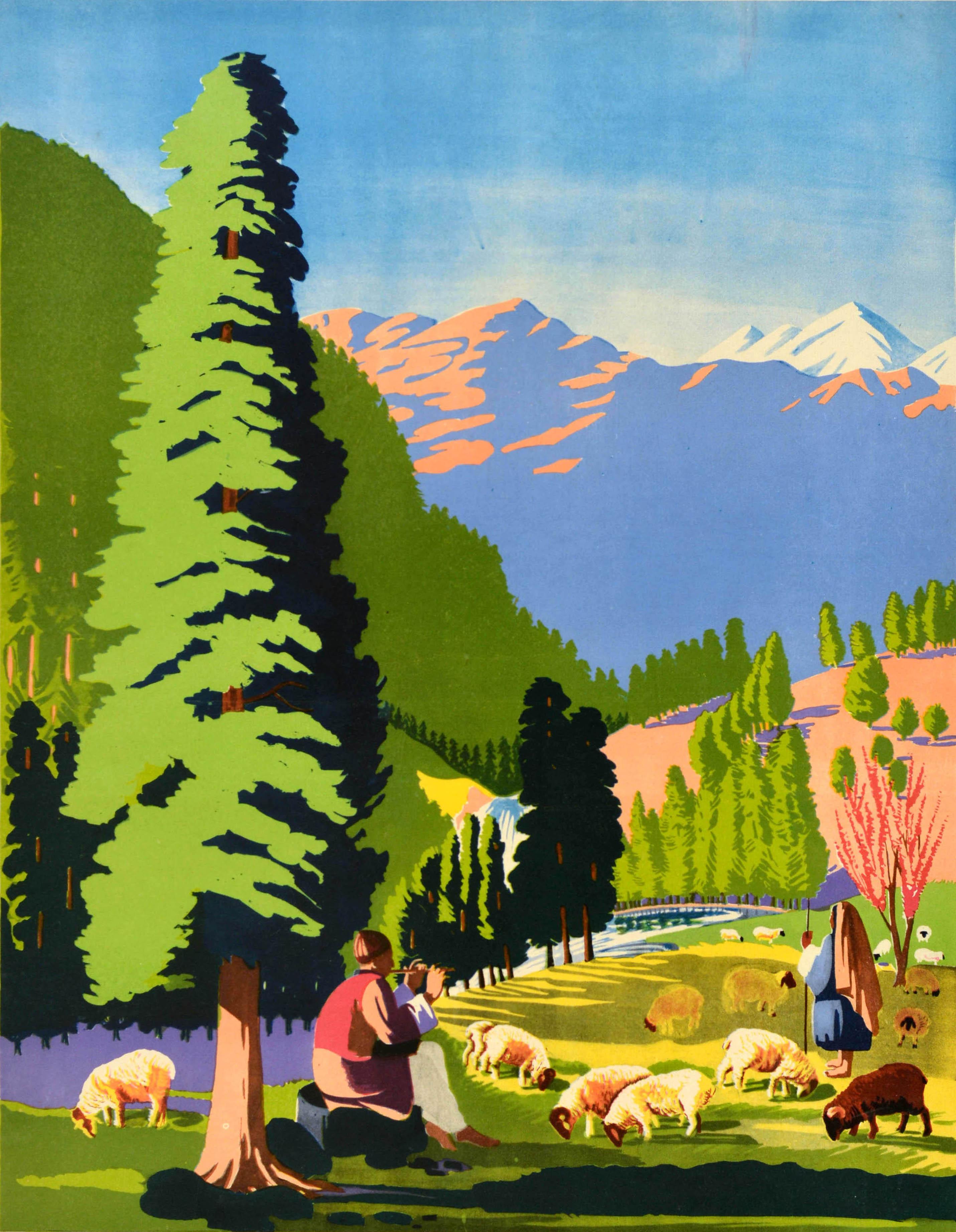 Original vintage travel poster - Visit Kashmir - featuring a scenic view of shepherds tending to their sheep on a green field, one sitting and playing music on a flute under the shade of a tree with a waterfall and river, a tree with pink blossom