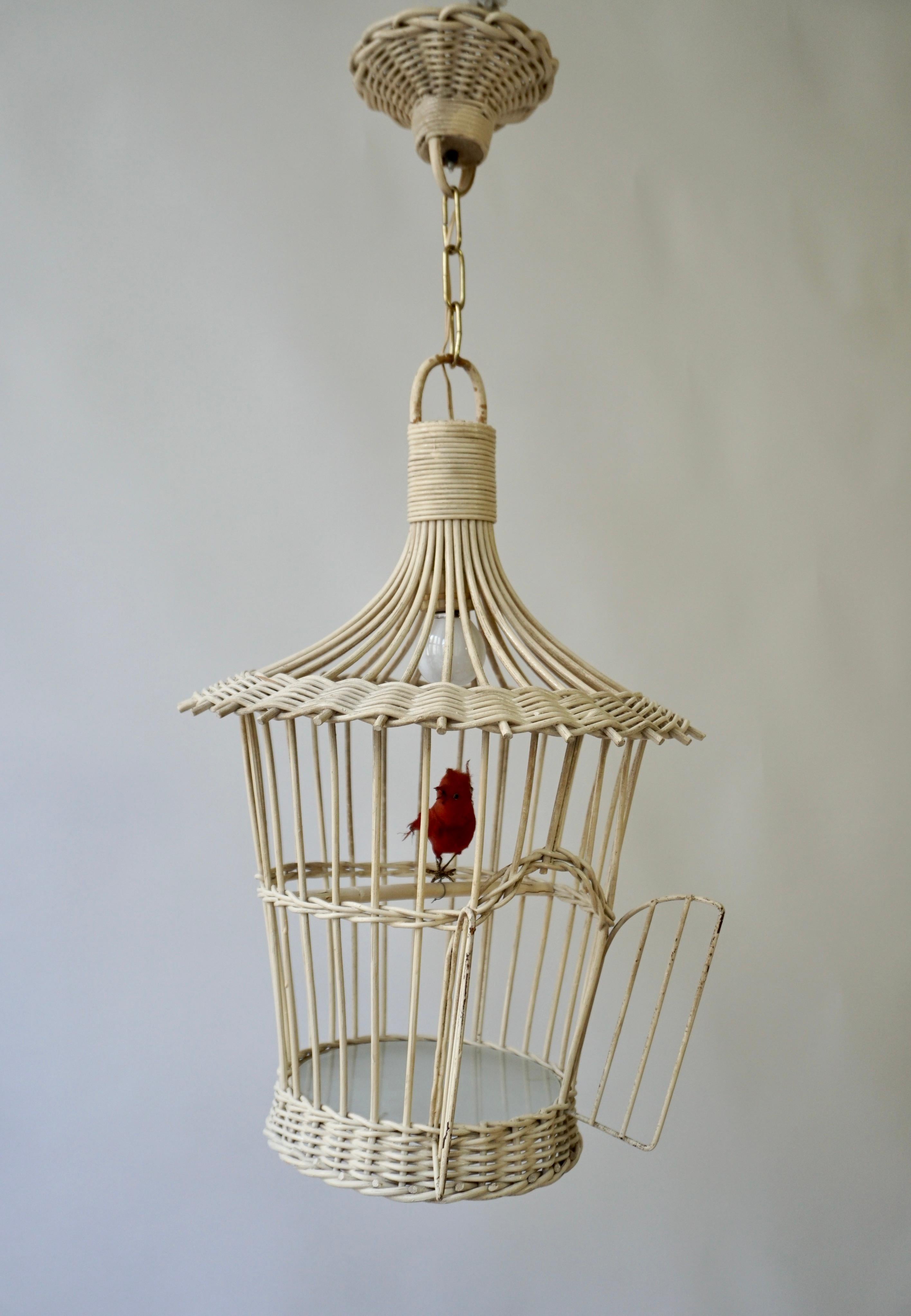 A real old birdcage hanging lamp in rattan with bird and a round glass bottom.

The height including the chain and the ceiling plate is 27.5