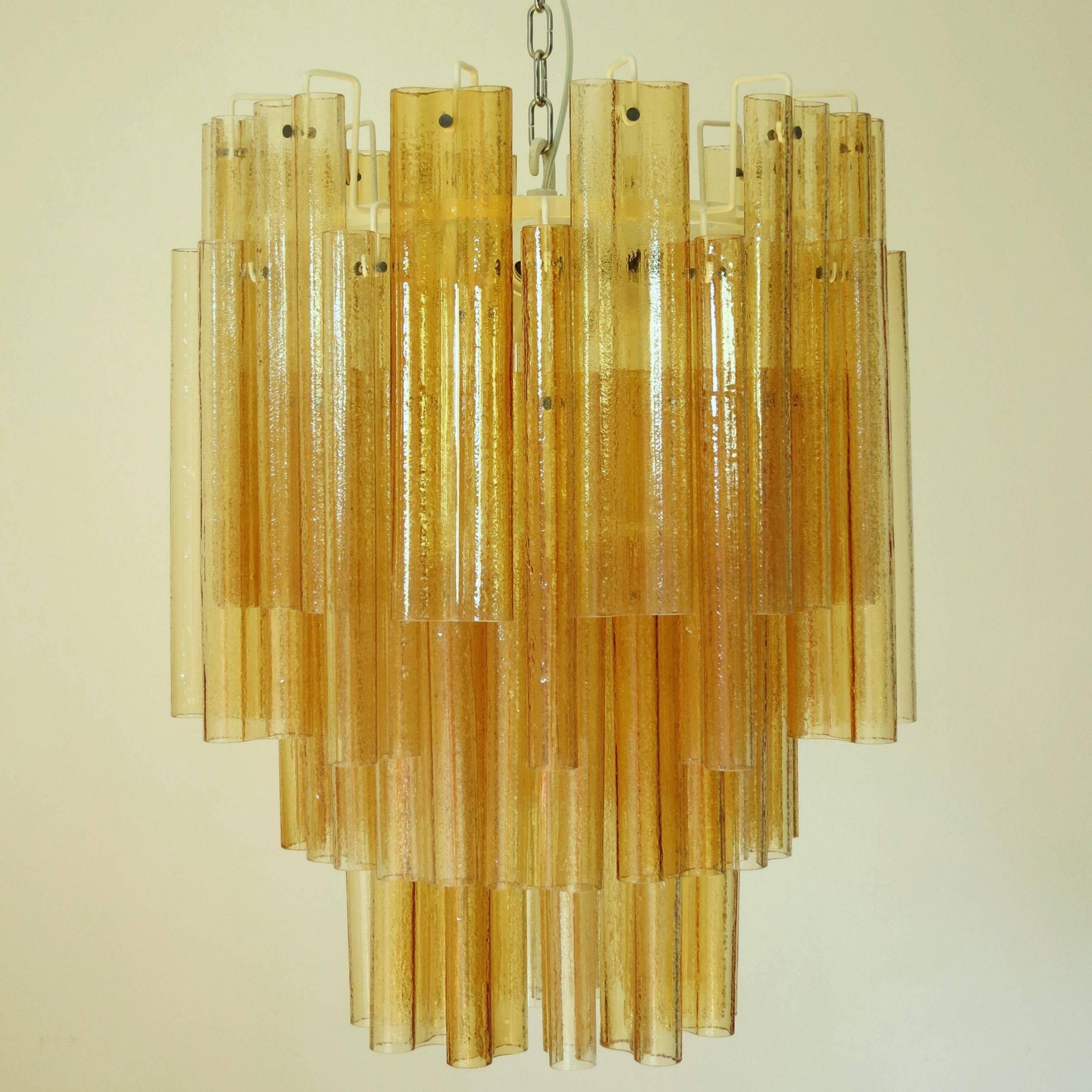 Original Italian vintage chandelier with hand blown amber Murano glass tubes, mounted on painted white metal frame / Attributed to Venini circa 1960s / Made in Italy.