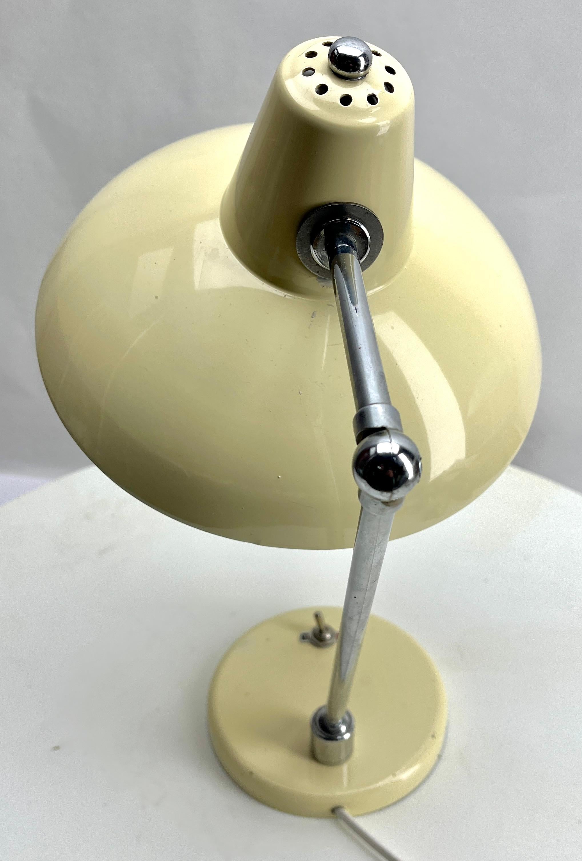 Classic compact design, this adjustable spotlight desk lamp Germany, 1950's
The Stand is metal and the flexible arm has chrome patina 
The lamp is in good Original condition.

Photography fails to capture the simple elegant illumination provided by