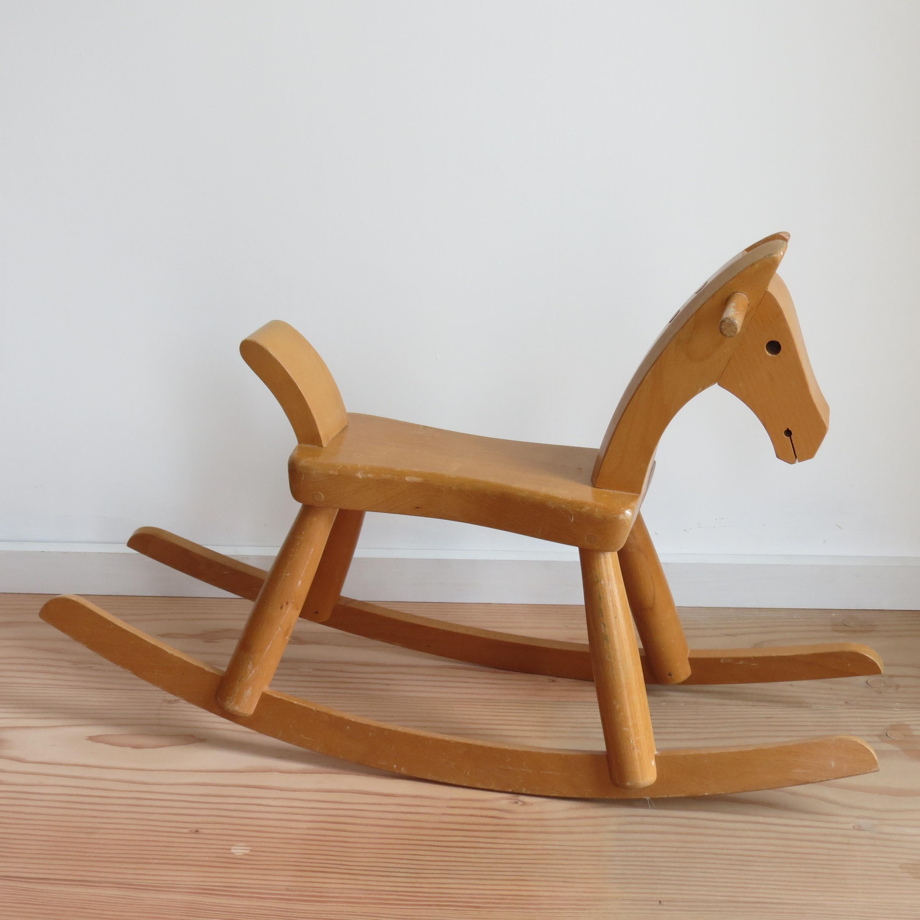 Original vintage Kay Bojesen rocking horse. Made from solid beech with a lacquered finish. Stamped to underside Kay Bojesen, Denmark.
Original design 1936

Measures: 77cm x 24cm wide by 47cm tall 
Seat height 26cm.
 
