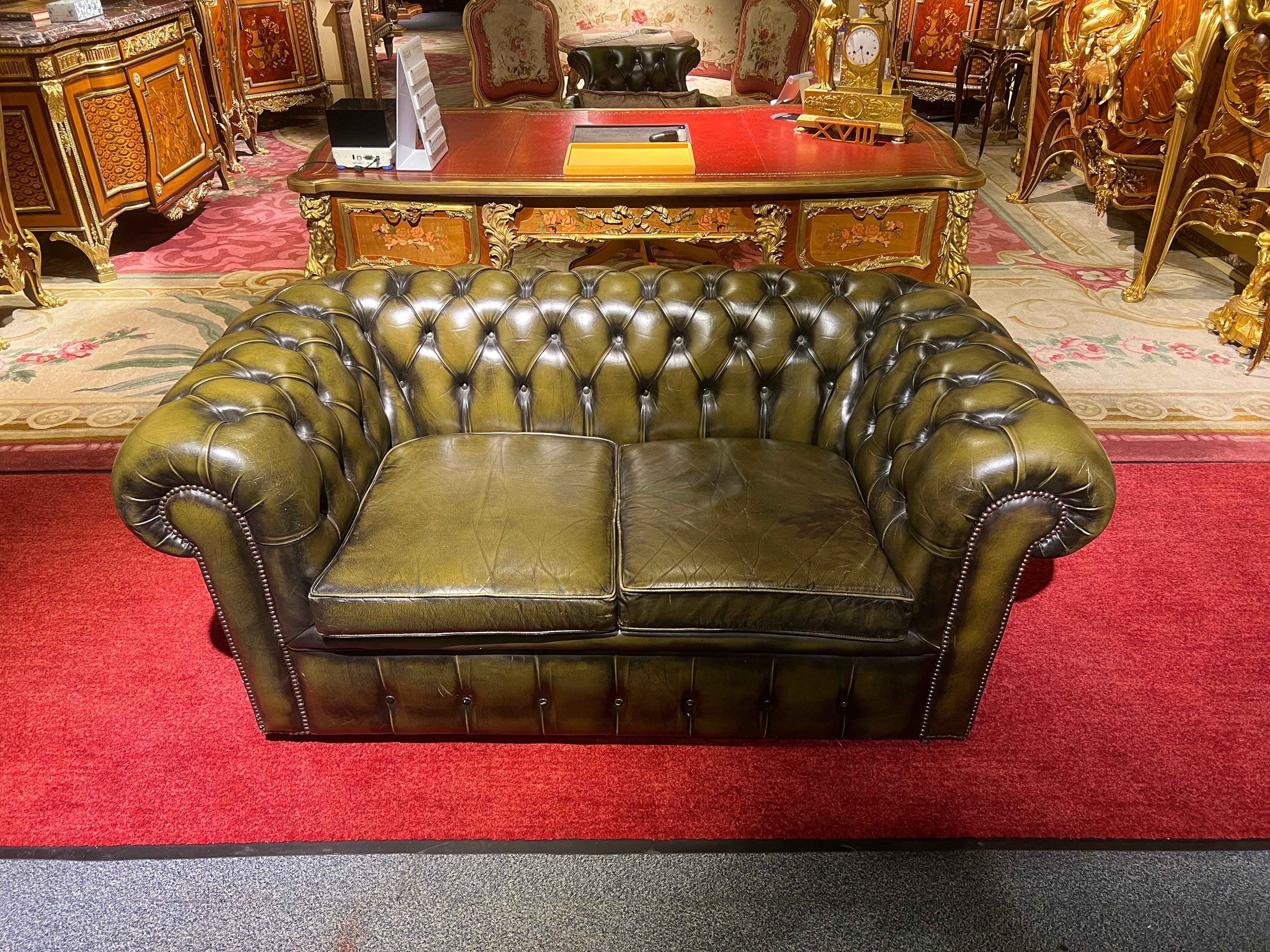 This original beautifully preserved Dark green leather small two-seat sofa is very masculine and small enough for an office. Coil sprung feather filled cushions - Vintage green leather Chesterfield sofa with original coil sprung front edge and