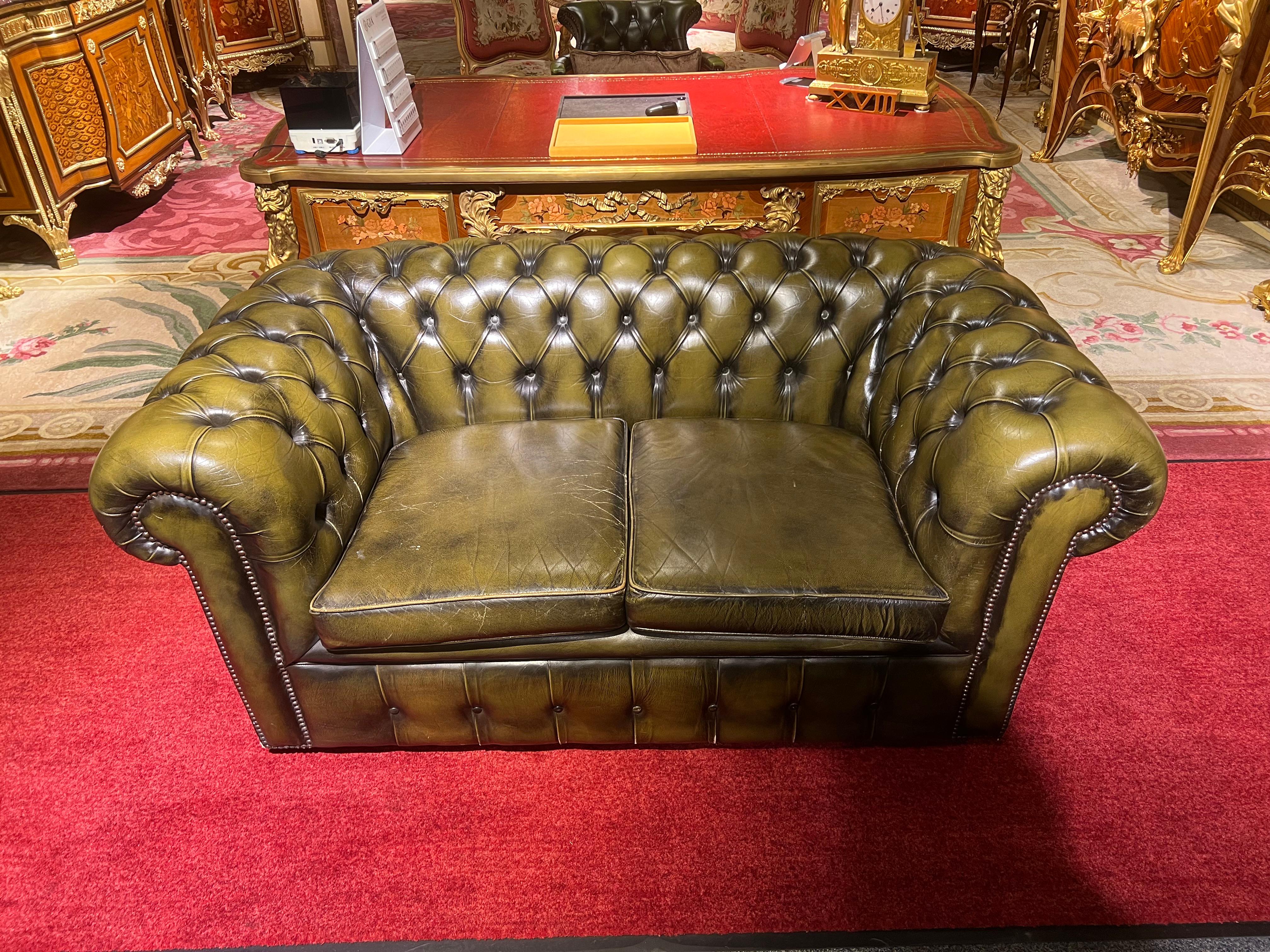 This original beautifully preserved Dark green leather small two-seat sofa is very masculine and small enough for an office. Coil sprung feather filled cushions - Vintage green leather Chesterfield sofa with original coil sprung front edge and