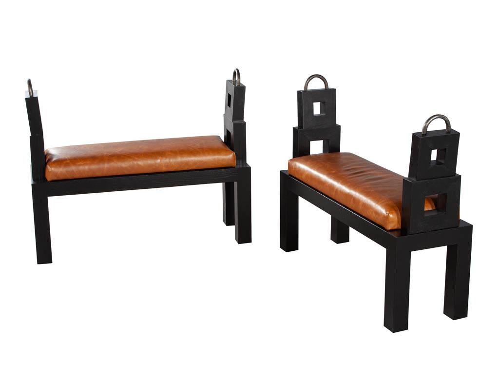 Original vintage fumed oak distressed saddle leather bench. Masterfully restored by the artisans at Carrocel in a newly upholstered distressed saddle leather. Rich black textured oak woods with hammered metal ring accents. Price includes