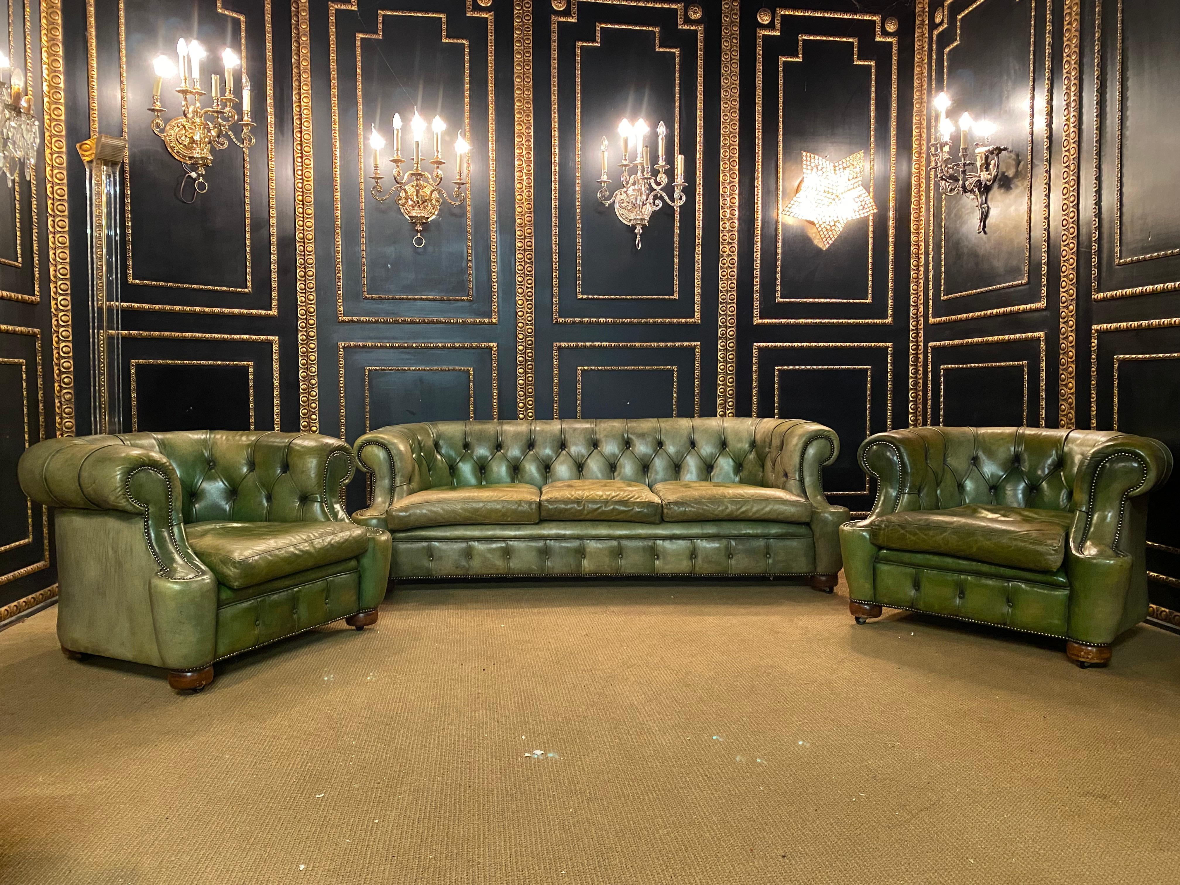 We are delighted to offer this stunning very rare handmade in England green leather sofa and armchairs. Where to begin! This suite is absolute eye candy from every angle, it has the original leather hide with horsehair. it has been hand dyed this