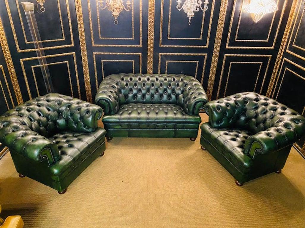 We are delighted to offer this stunning very rare handmade in England green leather sofa and armchairs. Where to begin! This suite is absolute eye candy from every angle, it has the original leather hide, it has been hand dyed this lovely and