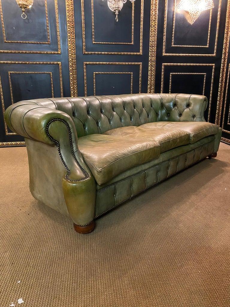We are delighted to offer this stunning very rare handmade in England green leather sofa and armchairs. Where to begin! This suite is absolute eye candy from every angle, it has the original leather hide with horsehair. it has been hand dyed this
