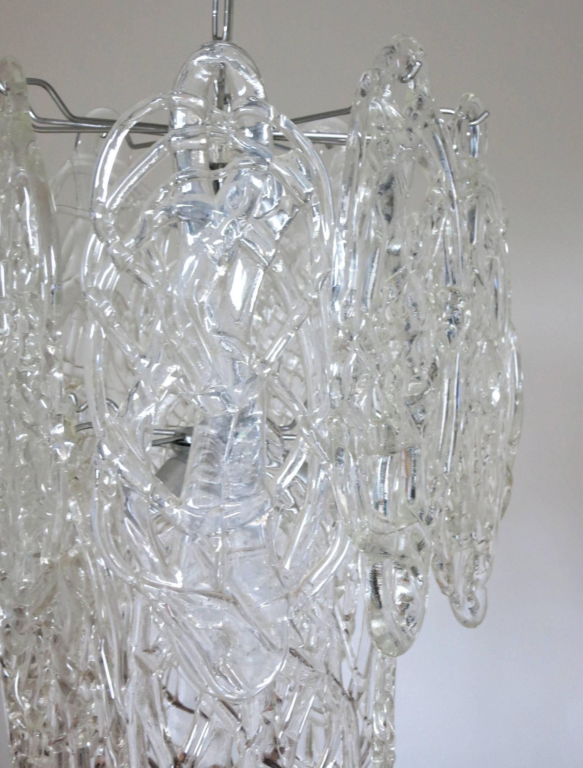 Original vintage Italian chandelier w/ clear murano glass blown in intricate cobweb-like pattern, mounted on chrome metal frame. Designed by Vistosi circa 1960’s.