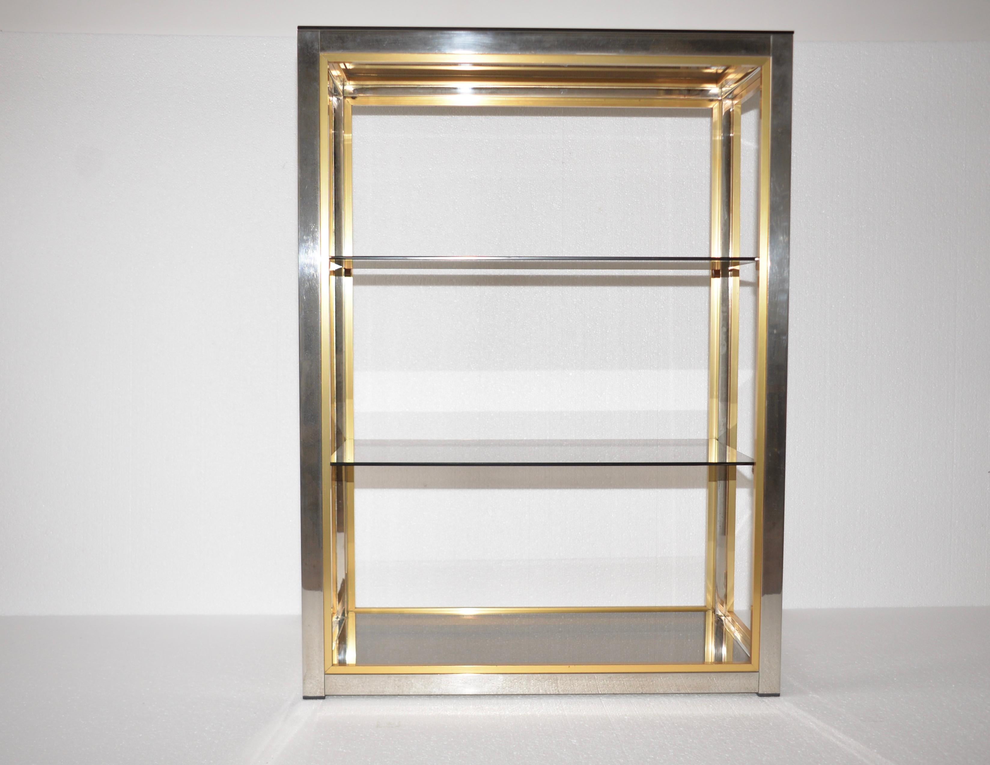An original Italian chrome shelving unit designed by Renato Zevi for Romeo Rega. A lovely item with four shelves within a polished chrome frame and it is also edged in brass in the Hollywood Regency Style. An iconic piece well know and documented in