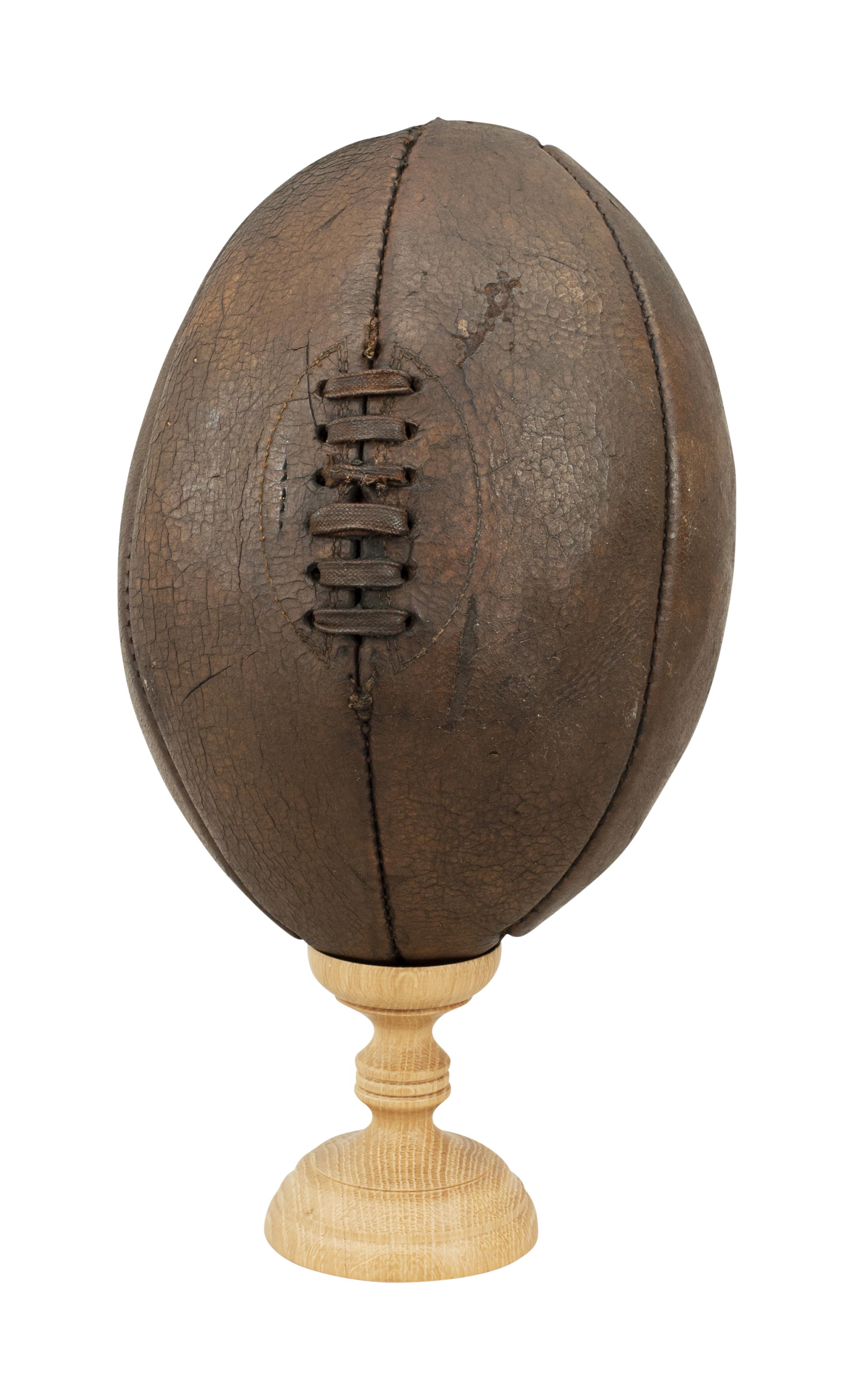 A good leather rugby ball made of six panels instead of the usual four panels.
The ball has had a lot of use and shoes its age well, with good color and patina.